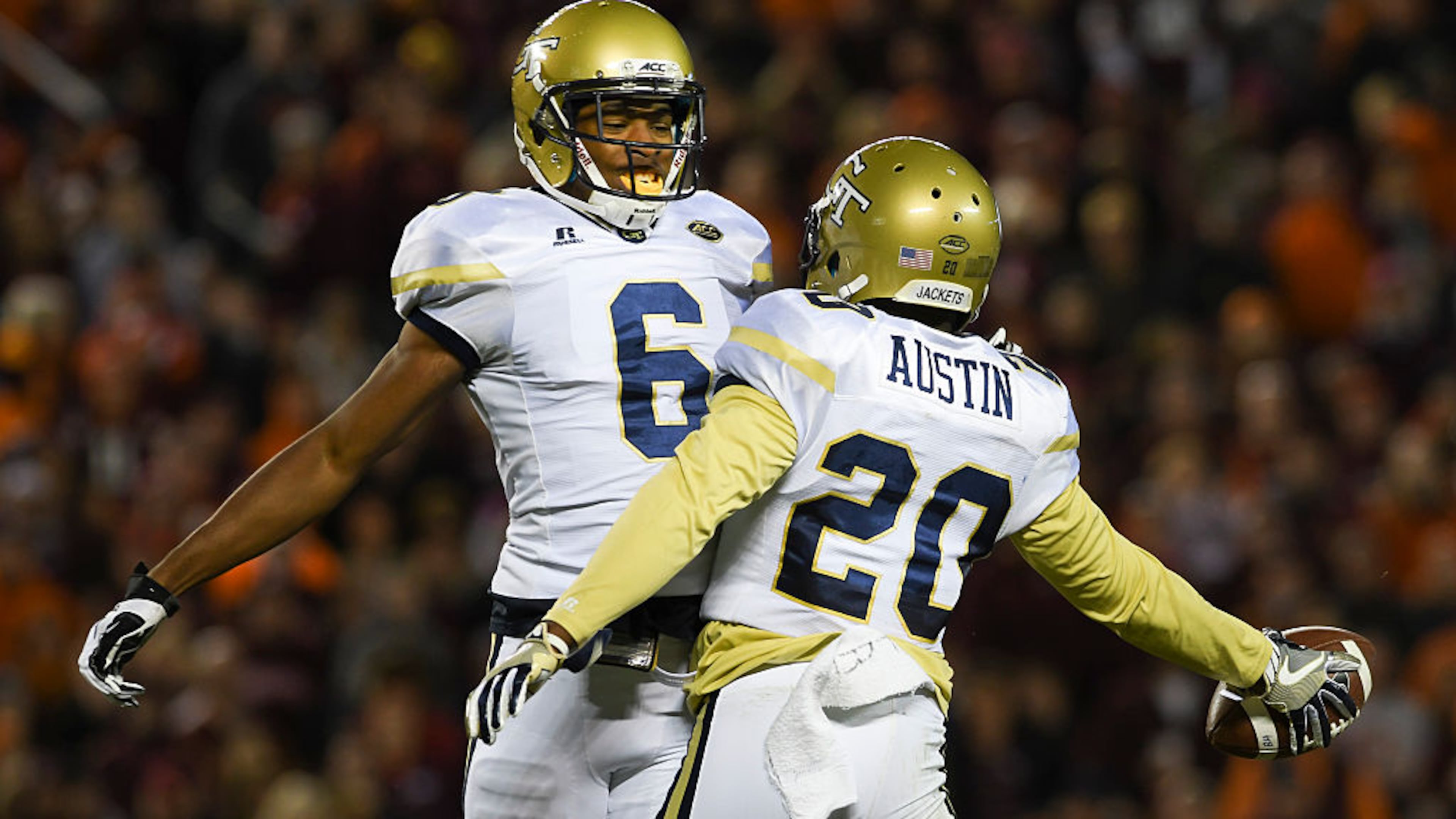 Defensive back Lawrence Austin #20 of the Georgia Tech Yellow Jackets celebrates his interception with defensive back Lamont Simmons #6 in the second half against the Virginia Tech Hokies at Lane Stadium on November 12, 2016 in Blacksburg, Virginia. Georgia Tech defeated Virginia Tech 30-20. (Photo by Michael Shroyer/Getty Images)