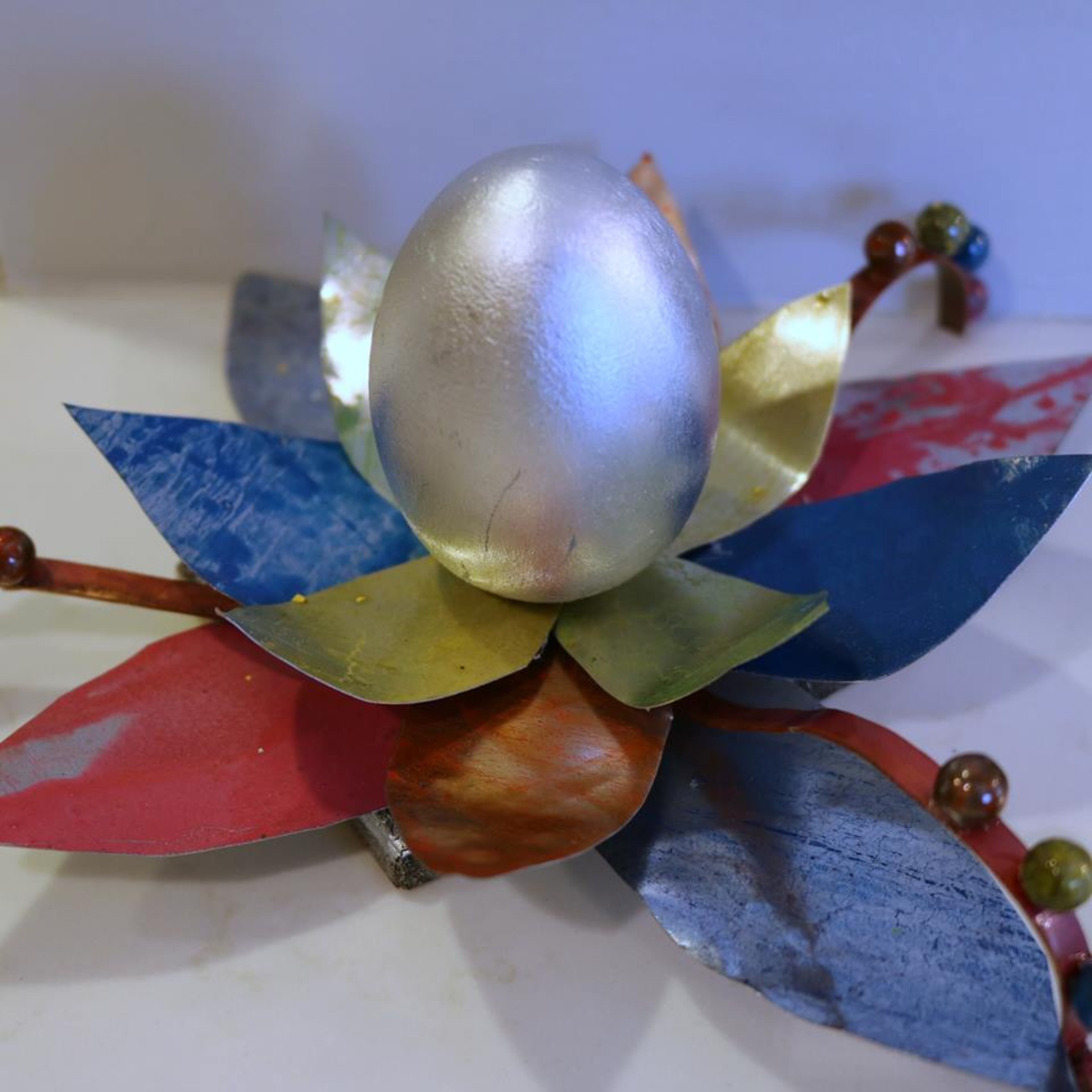 This gorgeous, one of a-kind-egg is entitled, “You Will Arrive At Nirvana All Shiny and Chrome”and this one will be up for grabs at this year’s upcoming artful Easter egg hunt.