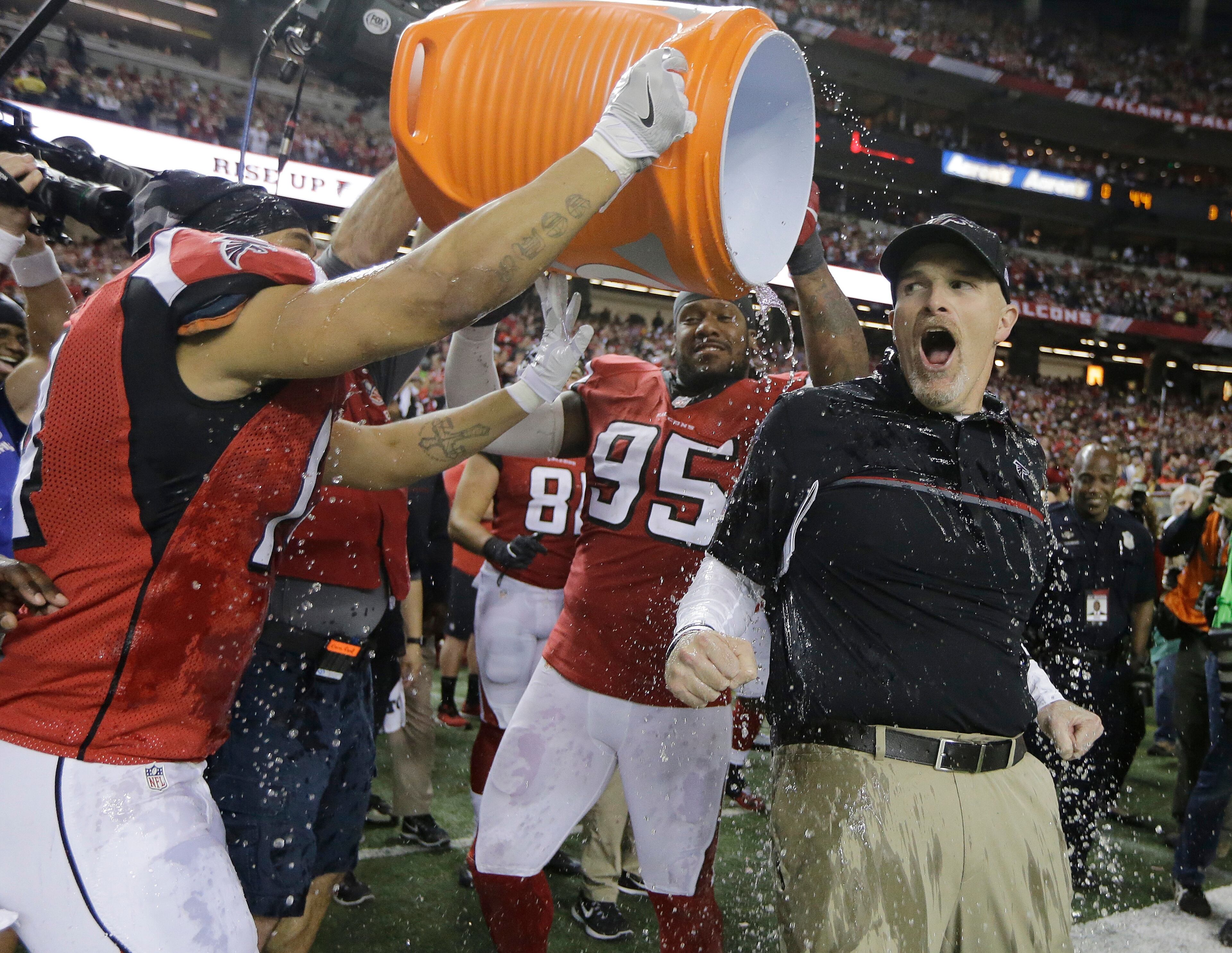 Atlanta Falcons head coach Dan Quinn reacts as he is dunked after the NFL football NFC championship game against the Green Bay Packers Sunday, Jan. 22, 2017, in Atlanta. The Falcons won 44-21 to advance to Super Bowl LI. (AP Photo/Mark Humphrey)