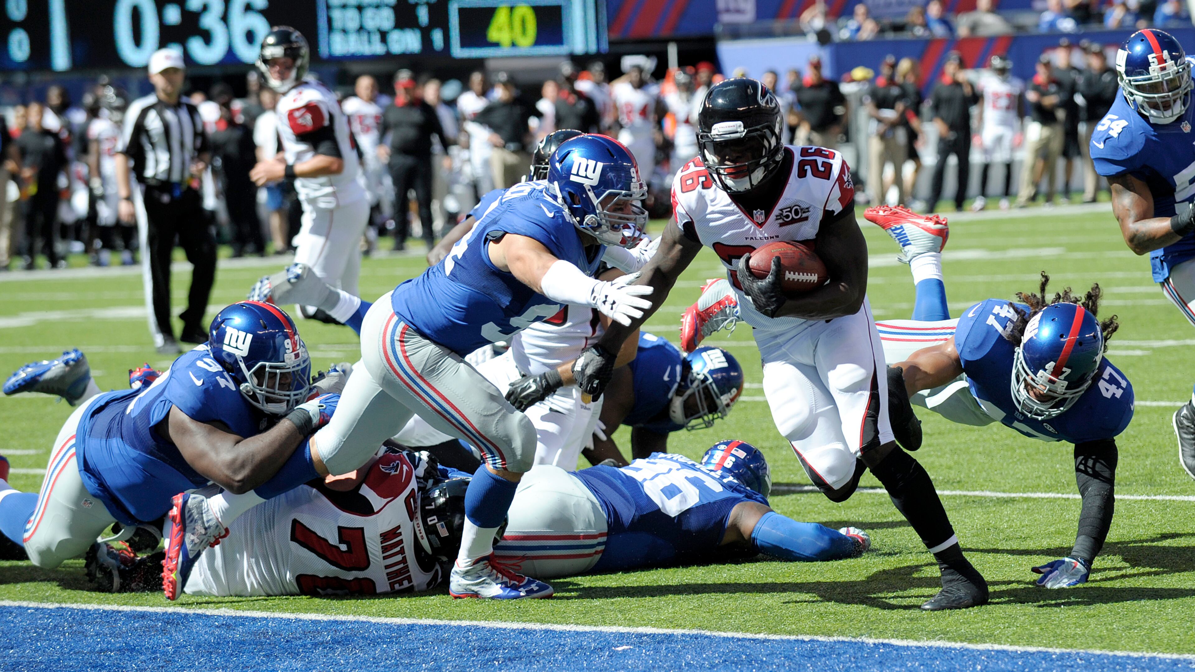 Atlanta Falcons running back Tevin Coleman (26) scores a touchdown against the New York Giants during the first half of an NFL football game, Sunday, Sept. 20, 2015, in East Rutherford, N.J. (AP Photo/Bill Kostroun)