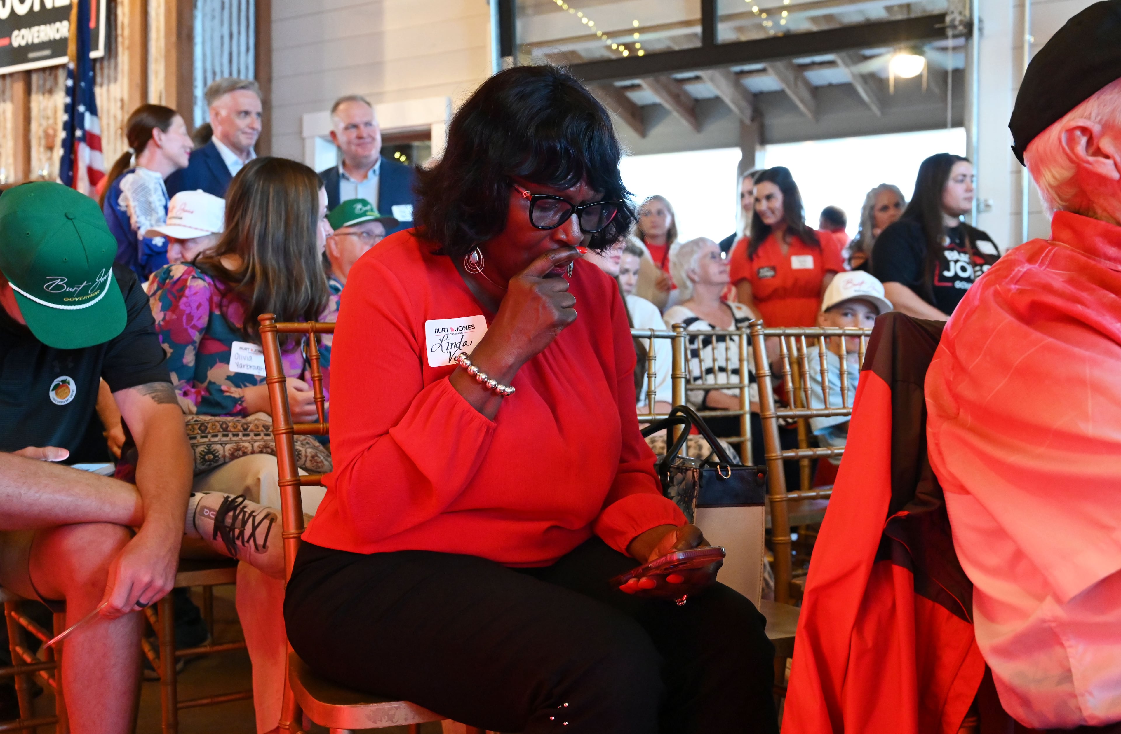 Supporters check election results on their phones during an election night watch party for Georgia gubernatorial candidate Burt Jones at The Rivers Ranch during Georgia’s primary runoff on Tuesday, June 16, 2026, in Jackson. (Hyosub Shin/AJC)