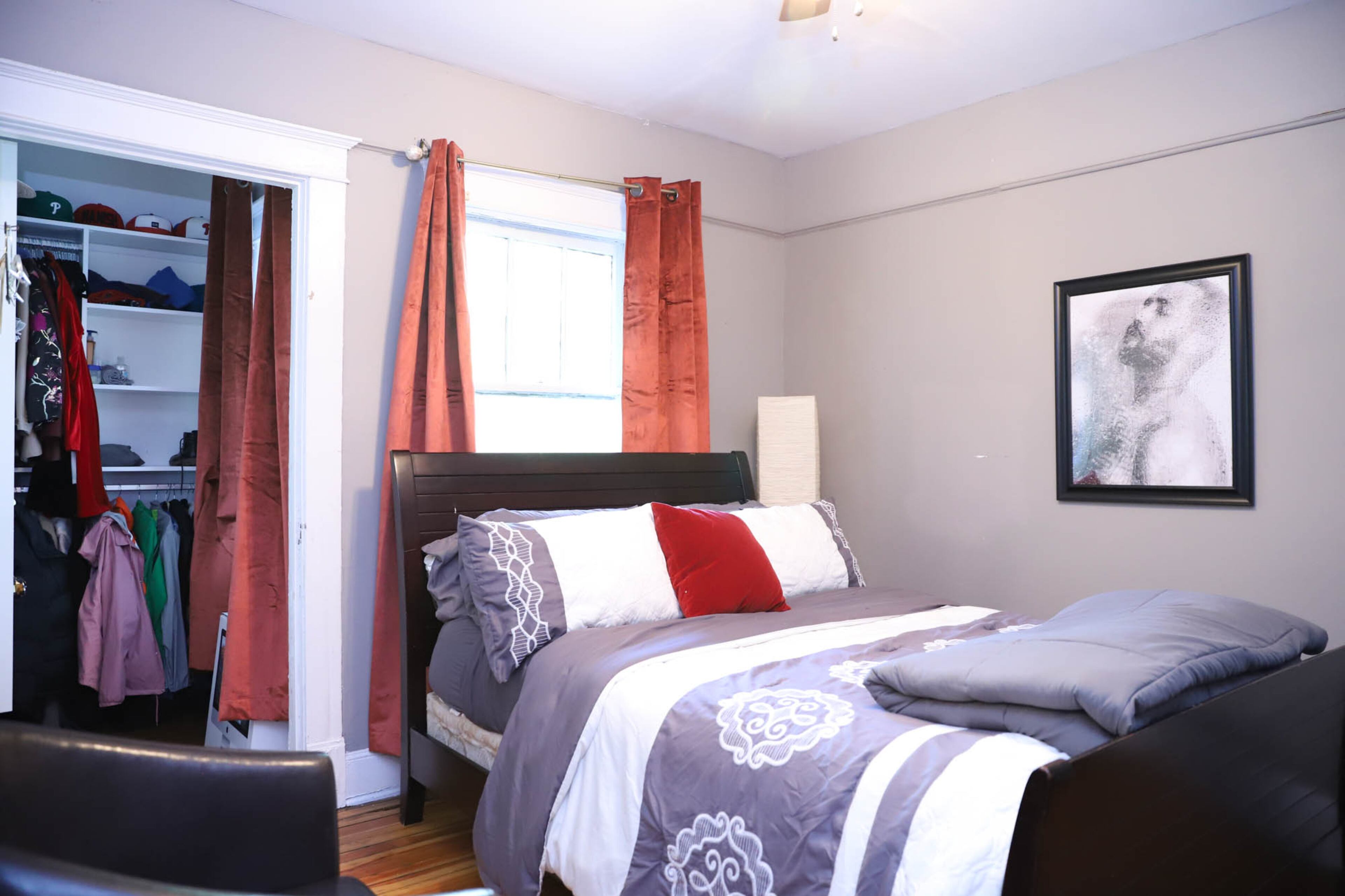 The other guest bedroom in Larry and Antoine Carter’s home is often kept ready for Larry’s mother to visit. Above the bed hangs a photograph of Larry that has been digitally distorted by a friend, who gifted Larry the print. Text by Shannon Dominy/Photo by Reynolds Rogers