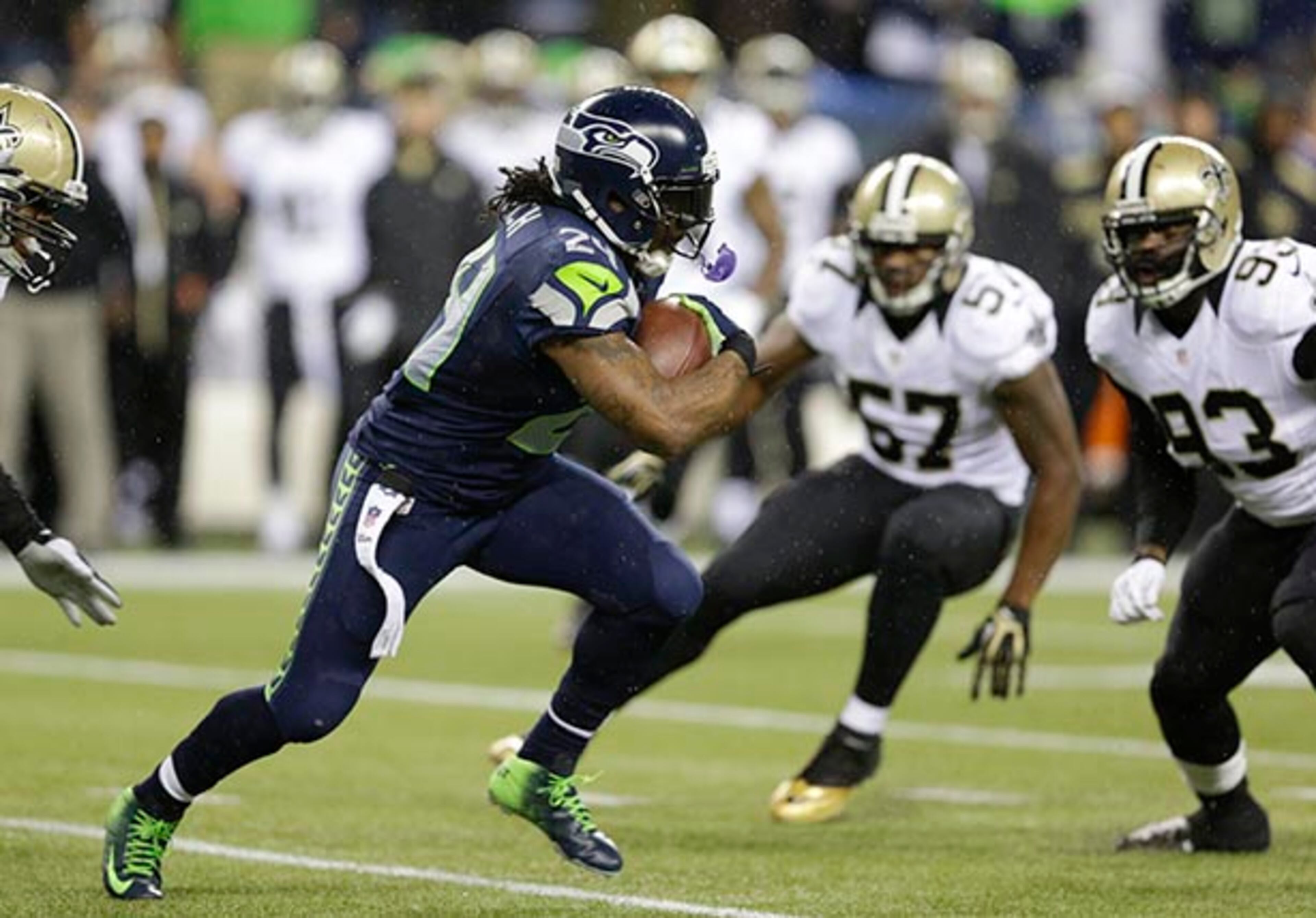 Seattle Seahawks running back Marshawn Lynch (24) runs against the New Orleans Saints in the first half of an NFL football game, Monday, Dec. 2, 2013, in Seattle. (AP Photo/Elaine Thompson)