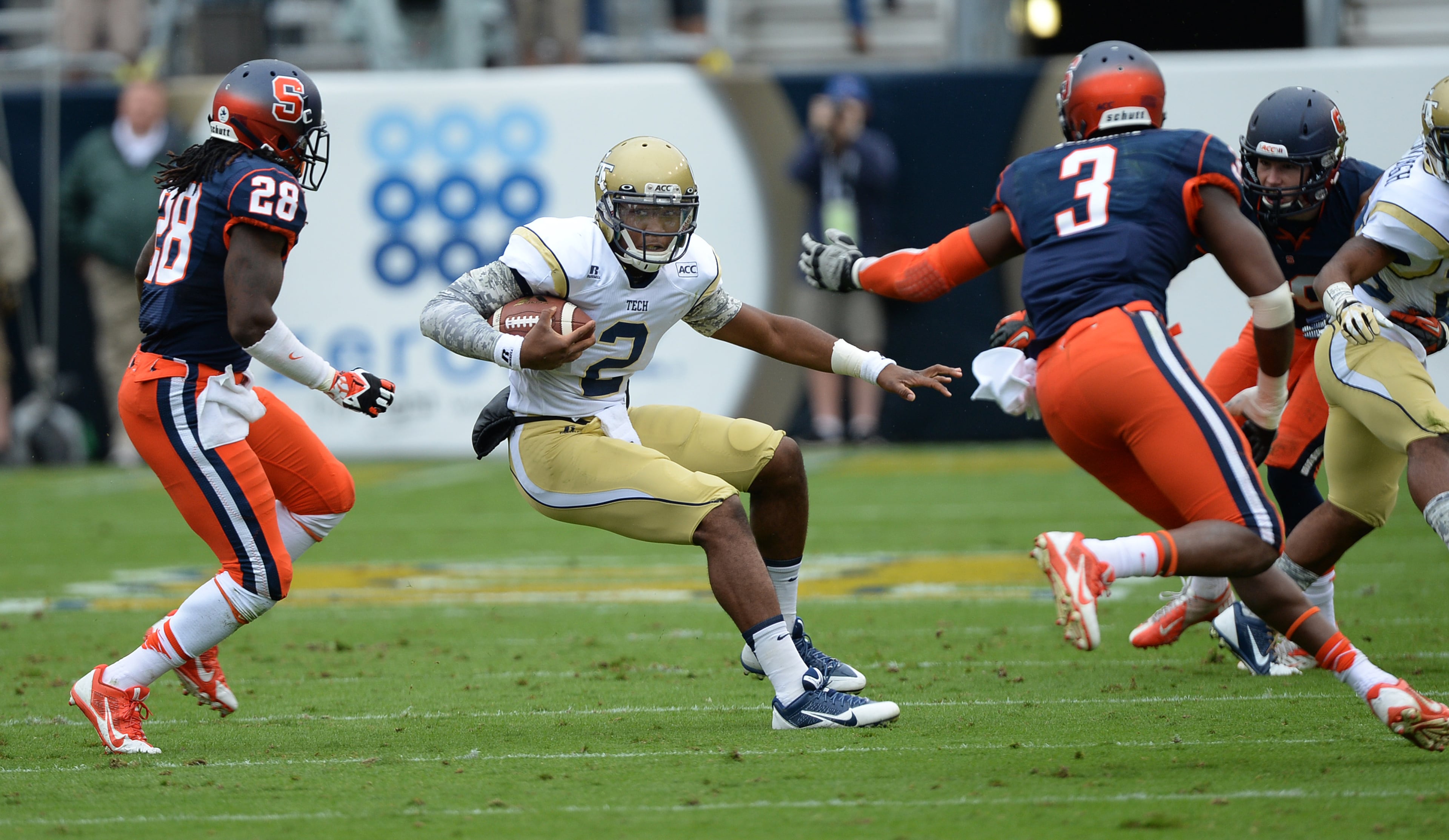Georgia Tech's Vad Lee (2) looks for a hole between two Syracuse defenders during a game in Bobby Dodd Stadium on Oct. 19, 2013. JOHNNY CRAWFORD / JCRAWFORD@AJC.COM