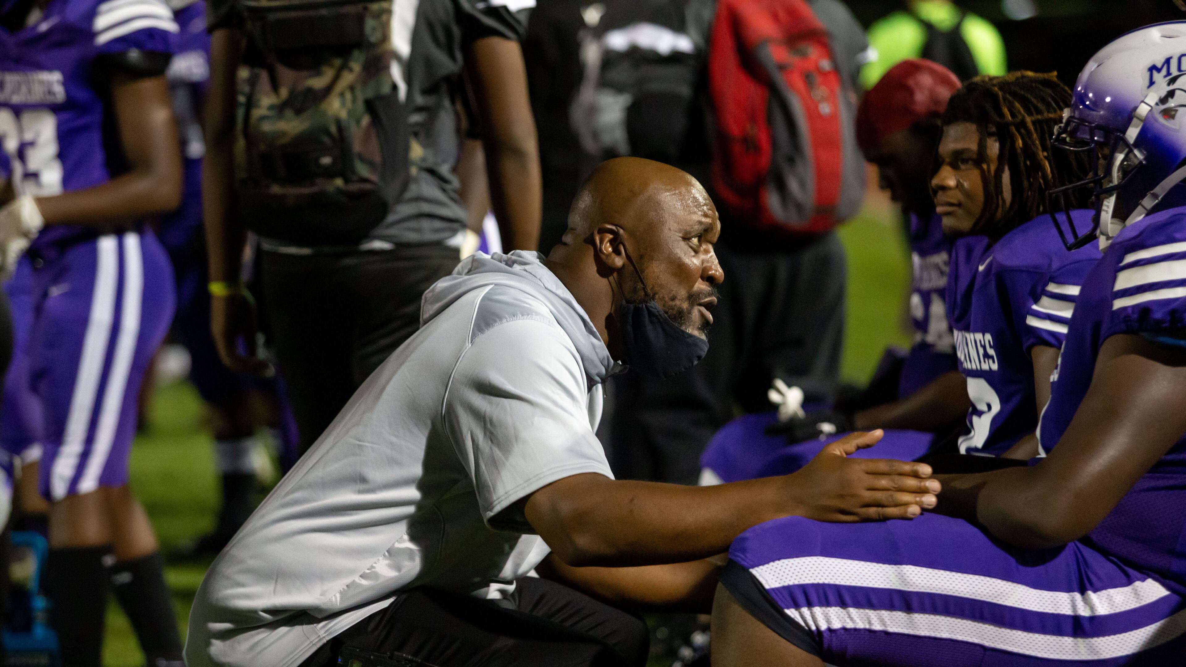 Miller Grove coach Melvin Brown talks with a player during a GHSA high school football game between Stephenson High School and Miller Grove High School at James R. Hallford Stadium in Clarkston, GA., on Friday, Oct. 8, 2021. (Photo/Jenn Finch)