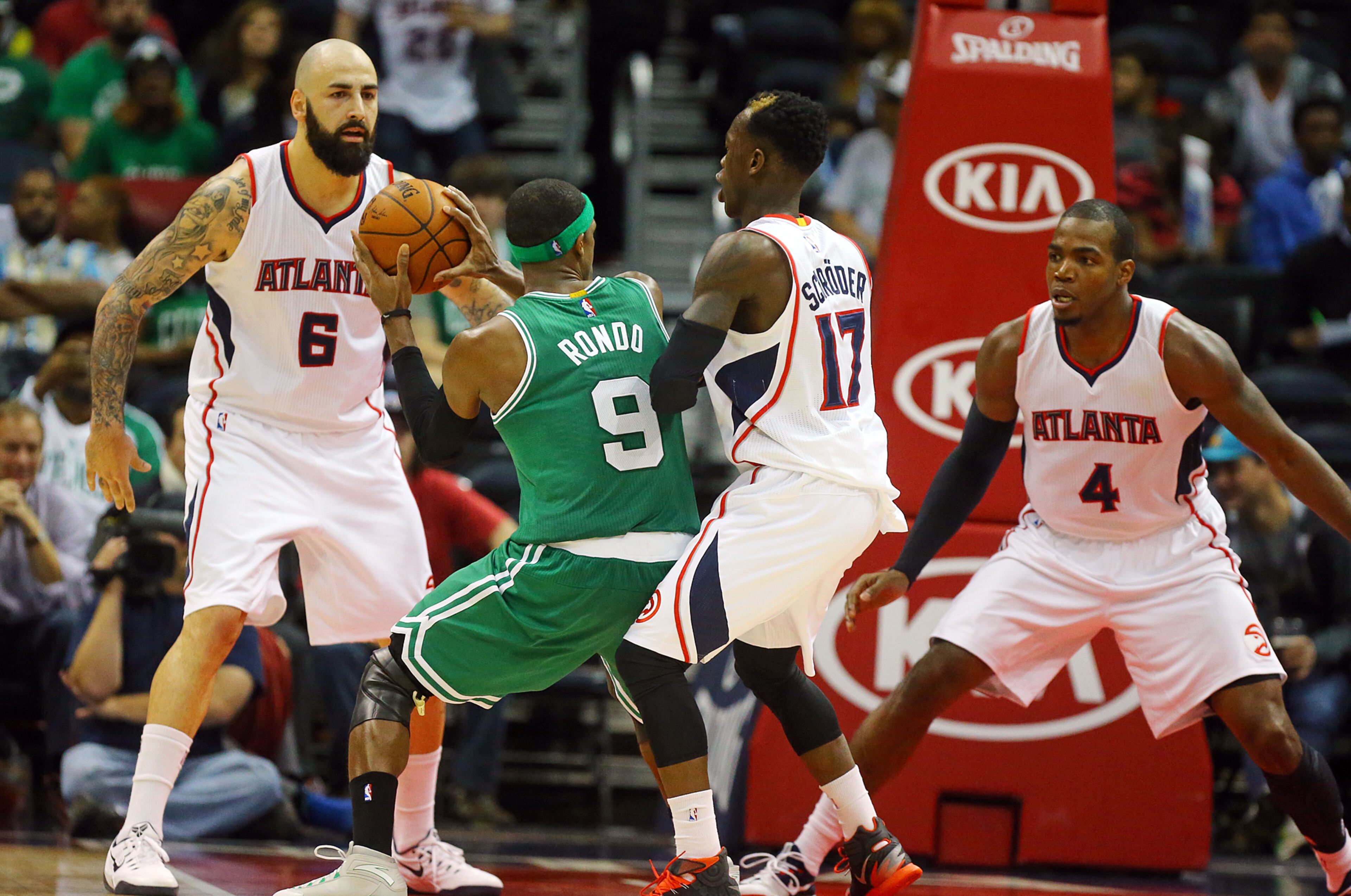 Celtics Rajon Rondo is triple teamed by Hawks defenders Pero Antic (from left), Dennis Schroder, and Paul Millsap during the second half in an NBA basketball game on Tuesday, Dec. 2, 2014, in Atlanta. CURTIS COMPTON / CCOMPTON@AJC.COM