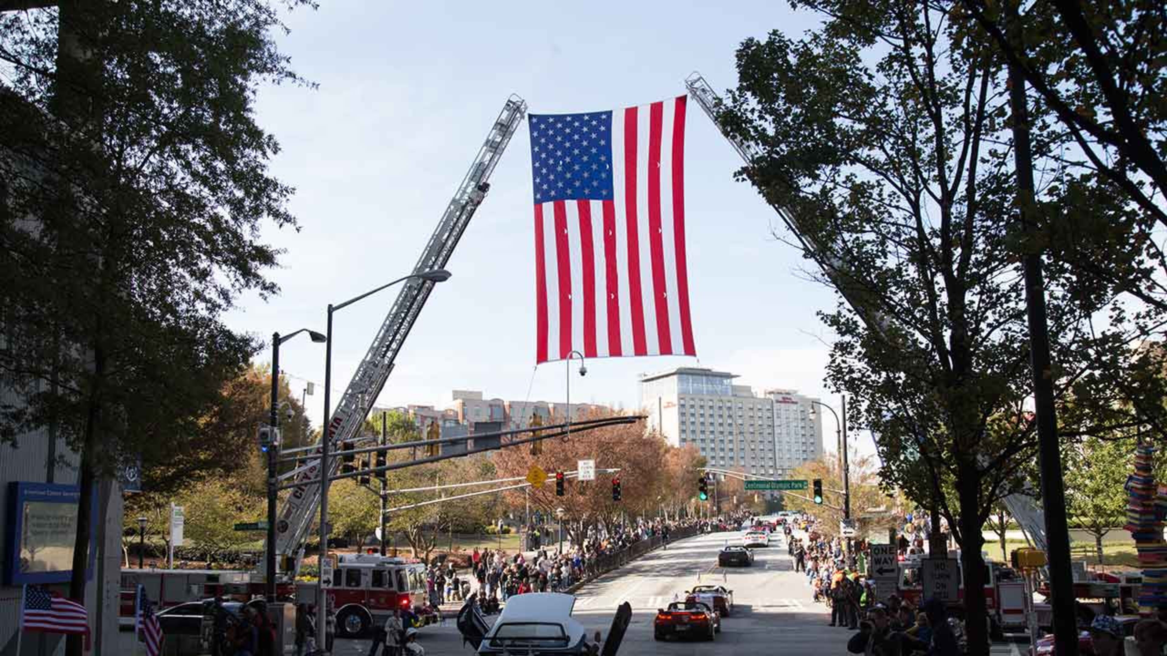 A large flag hangs over Baker Street during The Georgia Veterans Day Parade in downtown Atlanta Saturday, November 11, 2017.