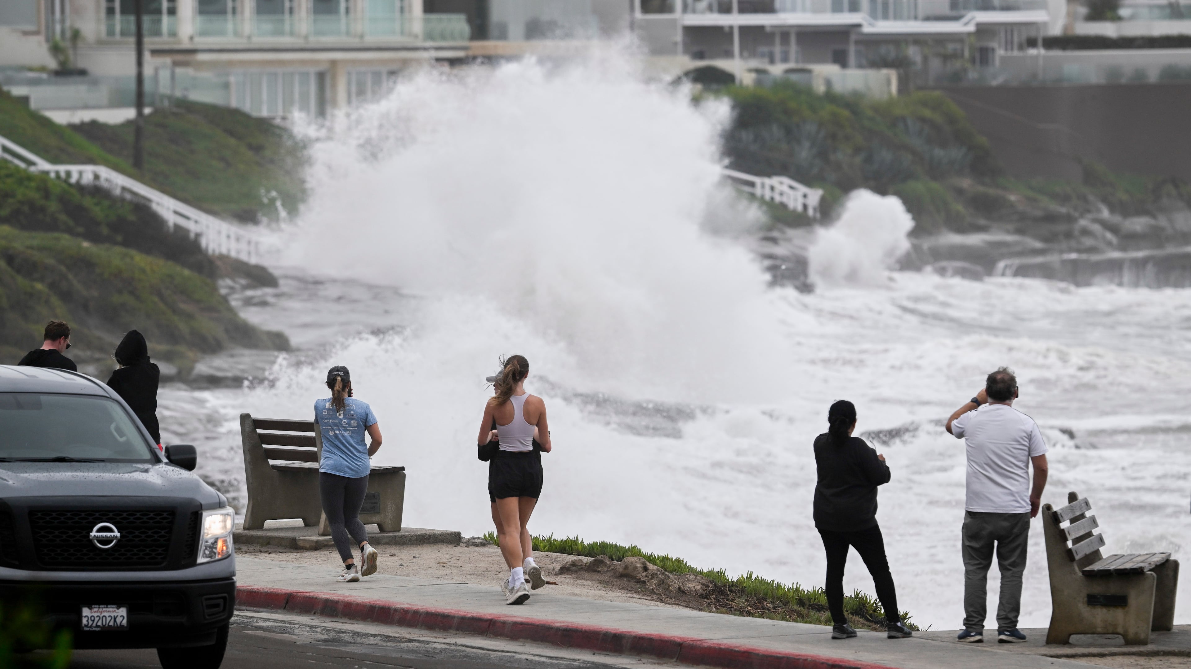 Onlookers watch as storm driven surf batters the bluffs in the La Jolla area of San Diego on Sunday, Oct. 11, 2026. (Denis Poroy/AP Photo)