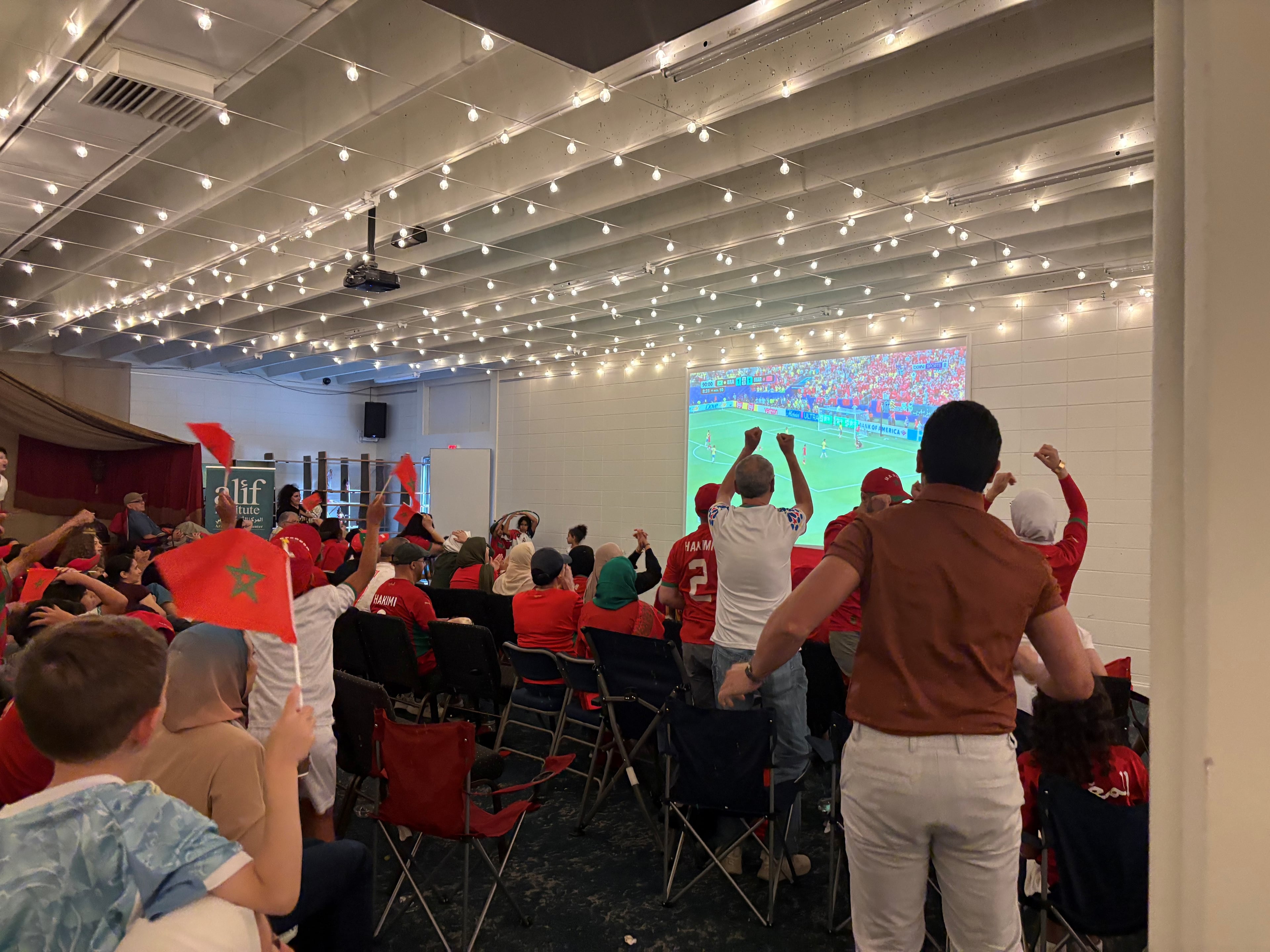 Moroccan fans cheer while watching the country take on Brazil in the 2026 World Cup.
