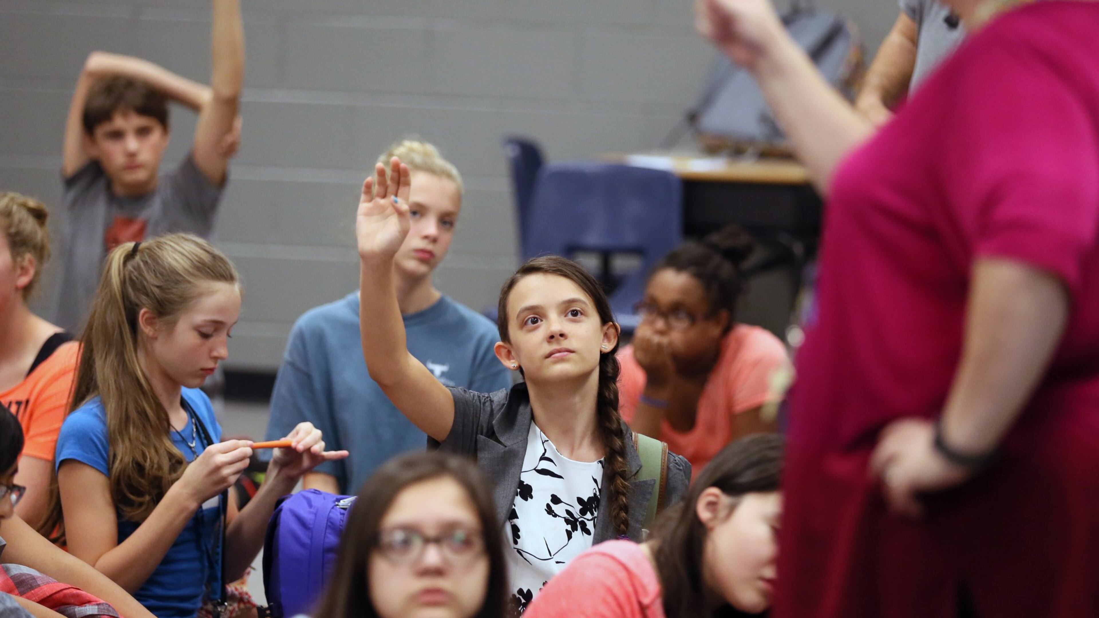 Ellie Kessler raises her hand at a session at Lanier Middle School in Sugar Hill beginning an annual project for a select number of eight graders under the school’s TWIST program. TWIST stands for Teamwork With Innovative Skills & Technology. The school is kicking off a program to involve more girls in science, technology, engineering and math courses. Georgia, like the rest of the nation, is struggling with an academic gender gap in science and math. BOB ANDRES /BANDRES@AJC.COM