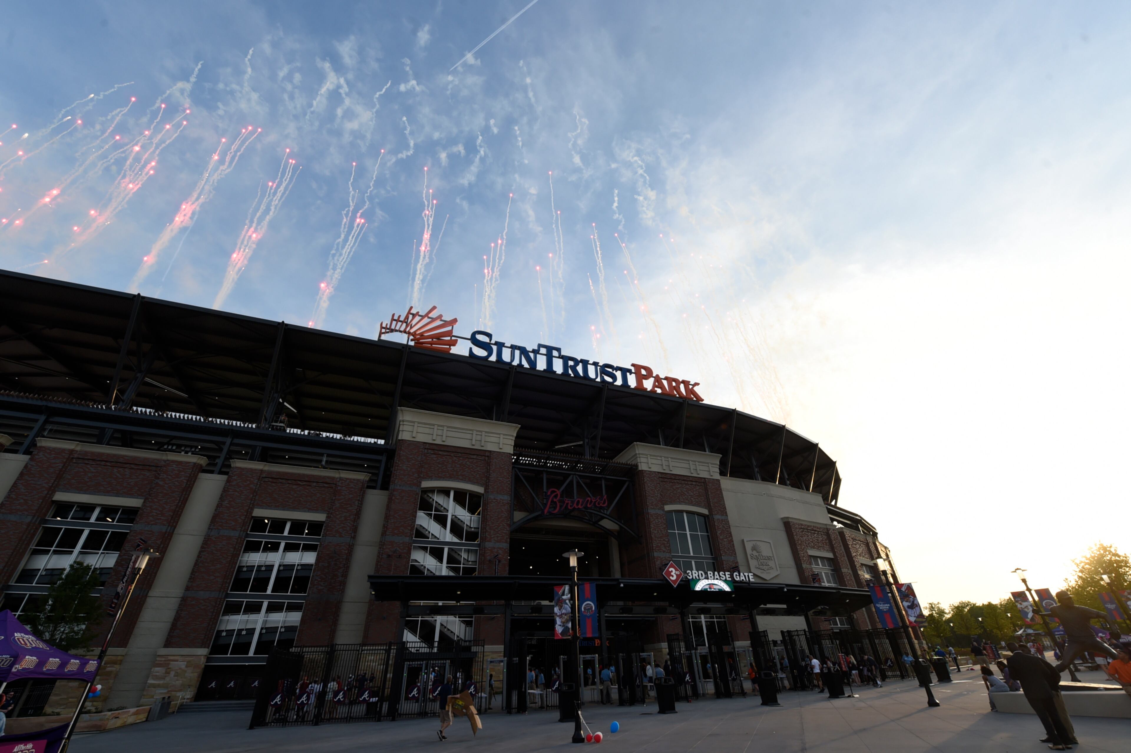 The exterior of the new stadium with fireworks firing off around it.