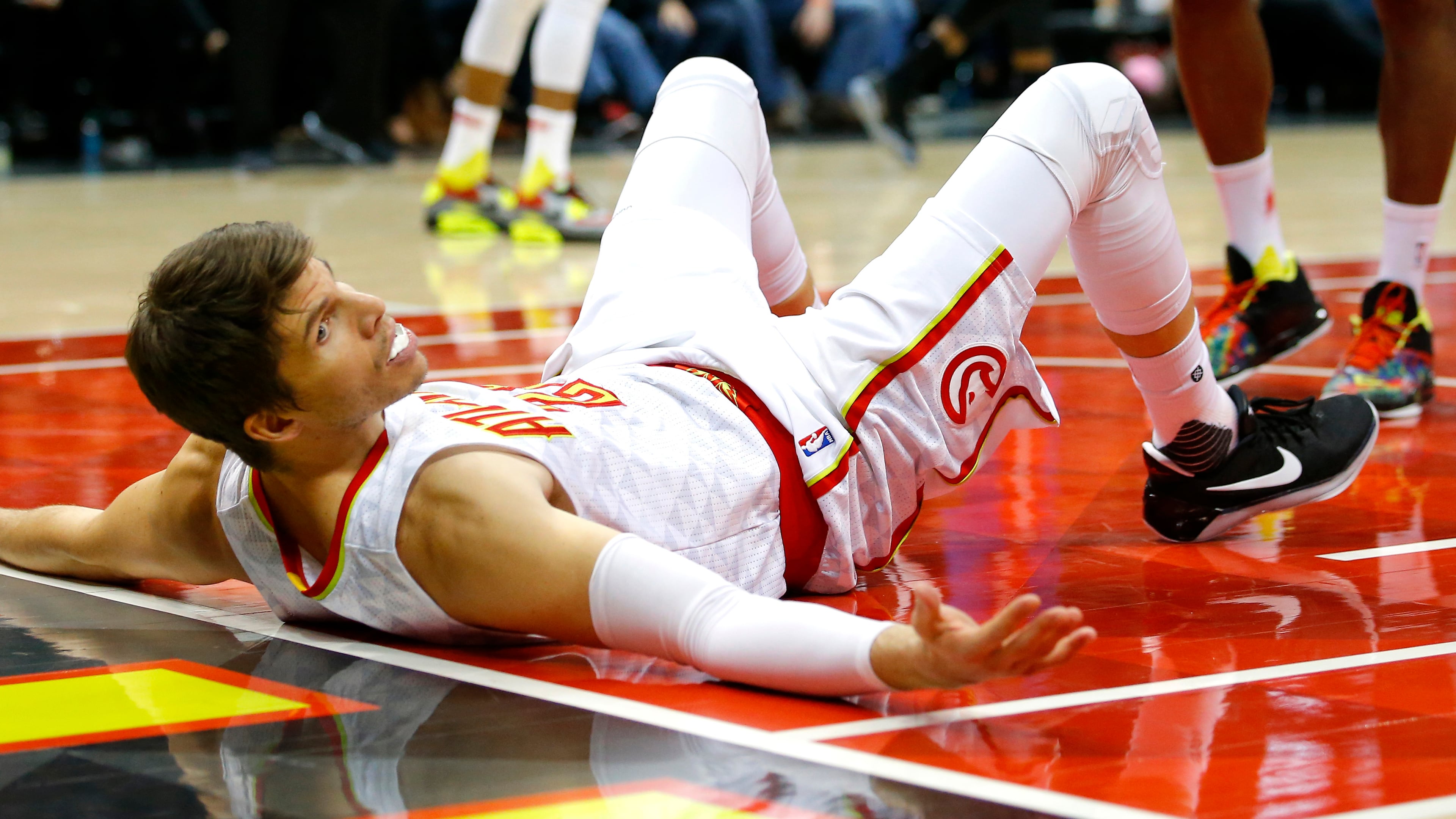 Atlanta Hawks guard Kyle Korver (26) reacts after being drawing an offensive foul against Detroit Pistons center Andre Drummond in the second half of an NBA basketball game on Friday, Dec. 30, 2016, in Atlanta. The Hawks won the game 105-98. (AP Photo/Todd Kirkland)