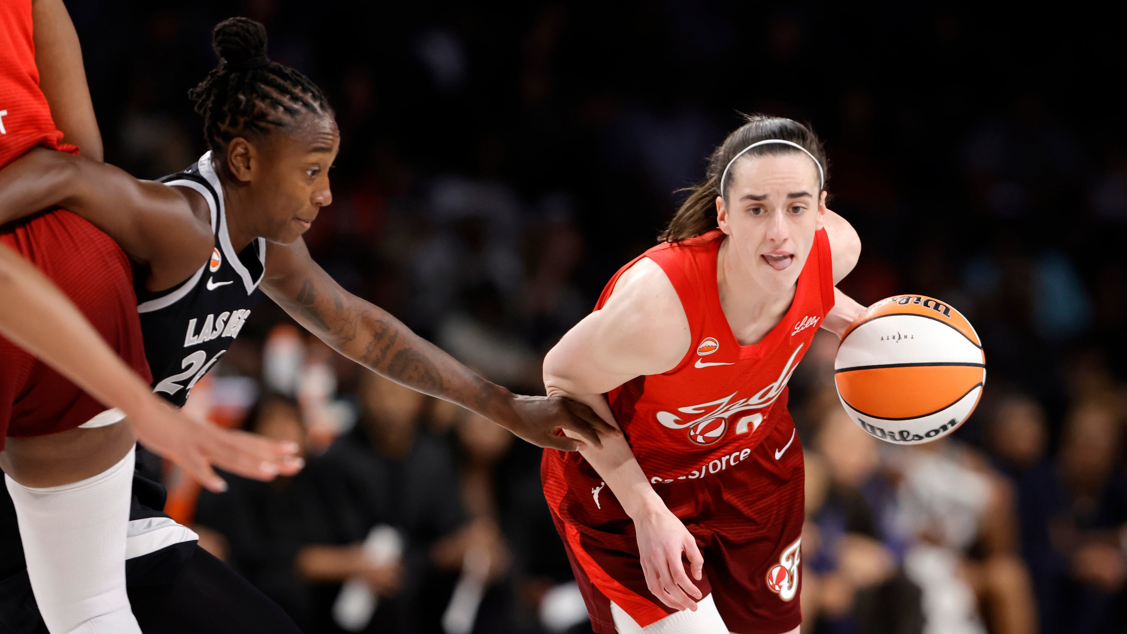 Indiana Fever guard Caitlin Clark (22) drives against Las Vegas Aces guard Jewell Loyd (24) during the first half in Game 3 of an WNBA basketball first-round playoff series Thursday, Oct.1, 2026, in Las Vegas. (AP Photo/Steve Marcus)