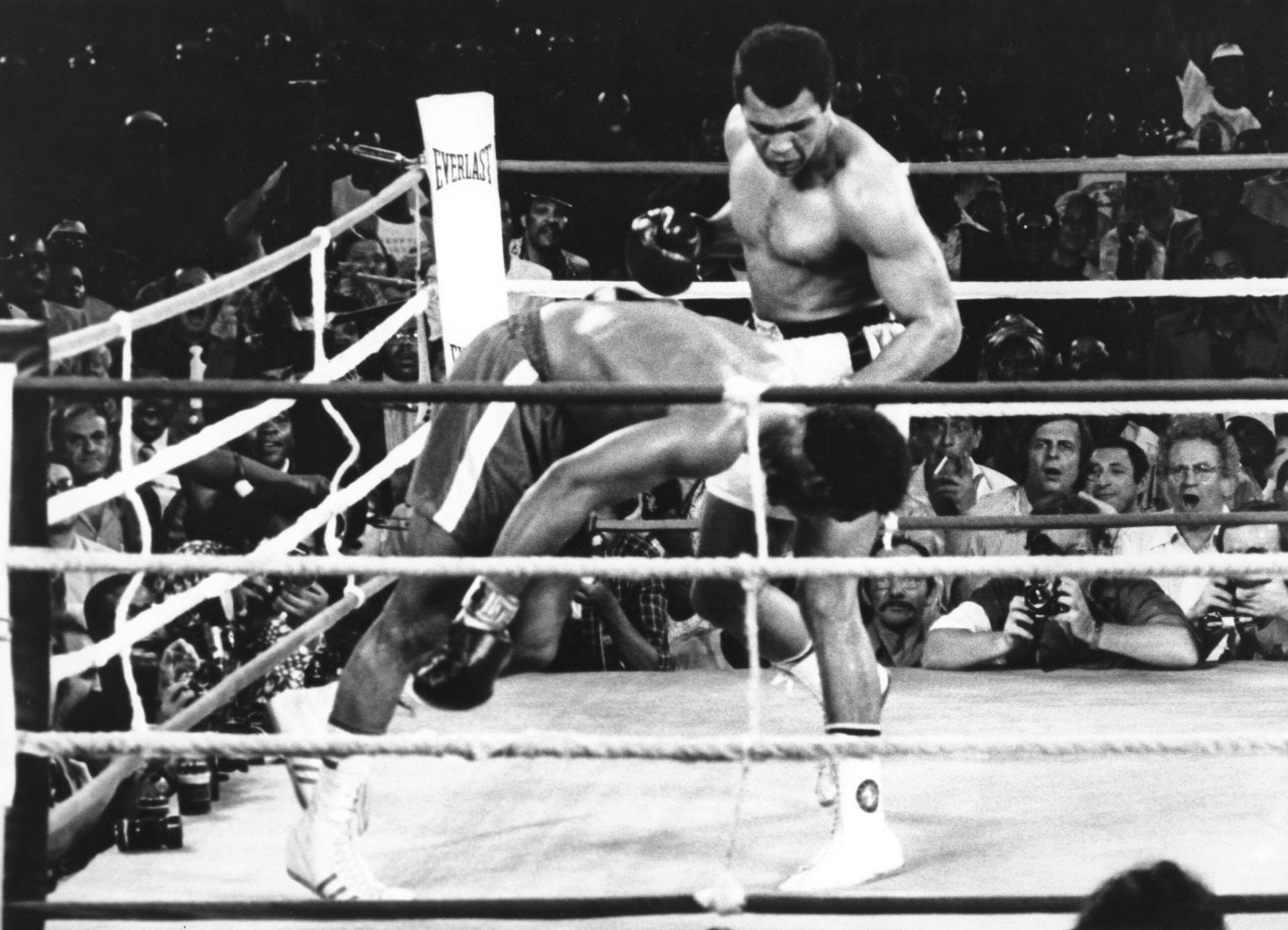 This is a Oct. 30, 1974 file photo of Muhammad Ali as he watches George Foreman head for the canvas after being knocked out in the eighth round of their match in Kinshasa, Zaire. It was nearly 42 years ago that two men met just before dawn on Oct. 30, 1974, to earn $5 million in the Rumble in the Jungle. In one of boxing's most memorable moments, Muhammad Ali stopped the fearsome George Foreman to recapture the heavyweight title in the impoverished African nation of Zaire. (AP Photo, File)