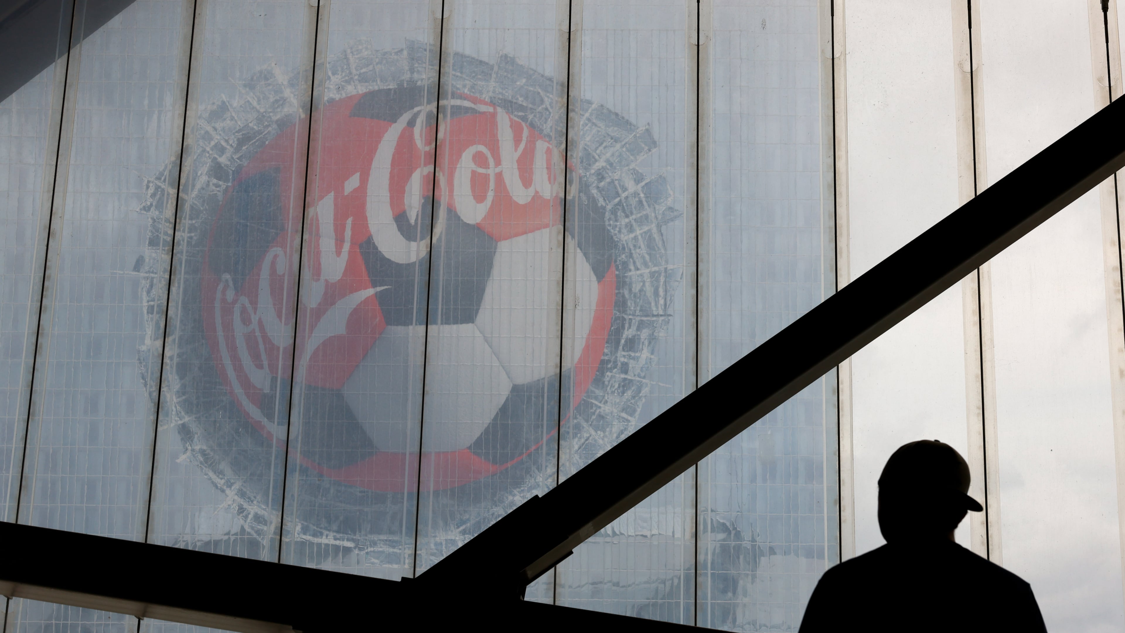 A fan looks at a Coca-Cola advertisement on downtown's Signia by Hilton hotel before the first half of the Czechia vs. South Africa game of the FIFA World Cup at Atlanta Stadium (Mercedes-Benz Stadium) on June 18, 2026. (Arvin Temkar/AJC)