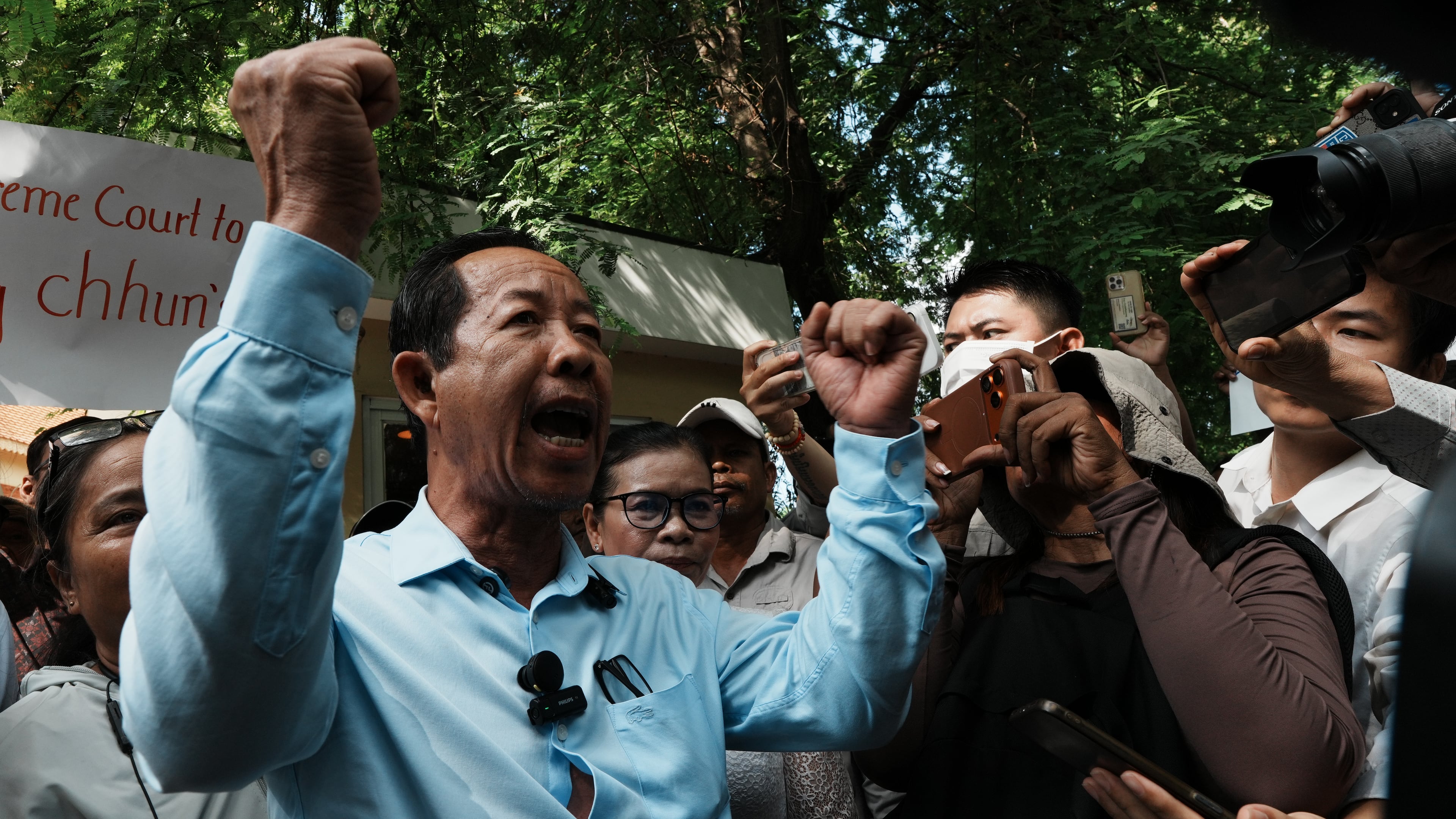 Rong Chhun, a prominent Cambodian opposition politician, gestures to his supporters after a Supreme Court hearing in Phnom Penh, Cambodia, Monday, June 15, 2026. (AP Photo/Heng Sinith)