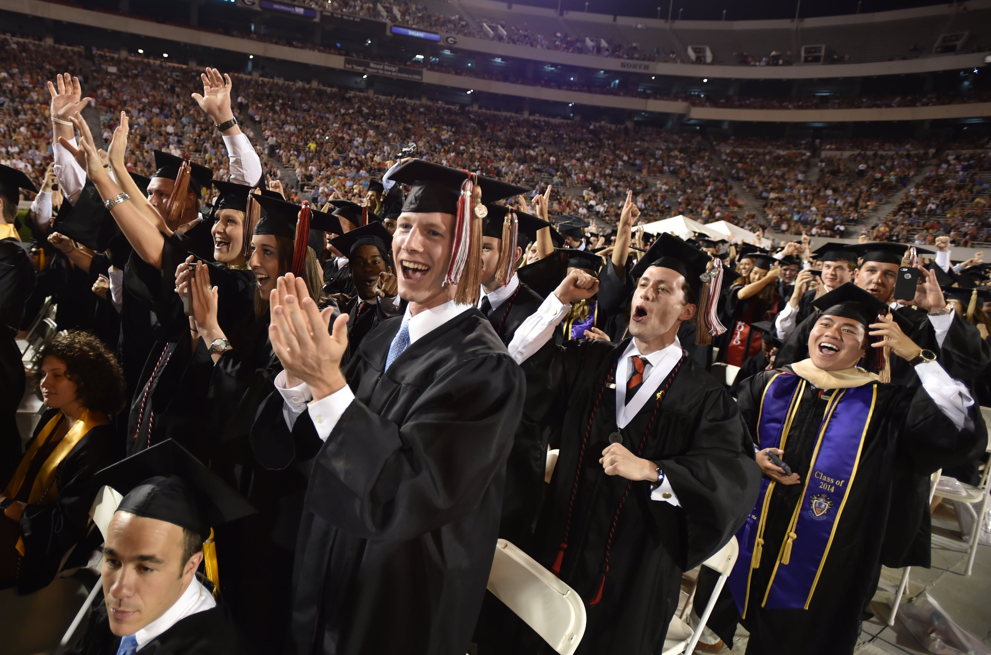 May 8, 2015 Athens, GA: University of Georgia students celebrate as their degrees are conferred during the undergraduate commencement at Sanford Stadium Friday May 8, 2015. Almost 4500 undergraduates had their degrees conferred during the ceremony. More than 1100 students received their Masters during a morning ceremony. Amy Robach, a 1995 alumna and news anchor for ABC's "Good Morning America" was the key note speaker. BRANT SANDERLIN/BSANDERLIN@AJC.COM