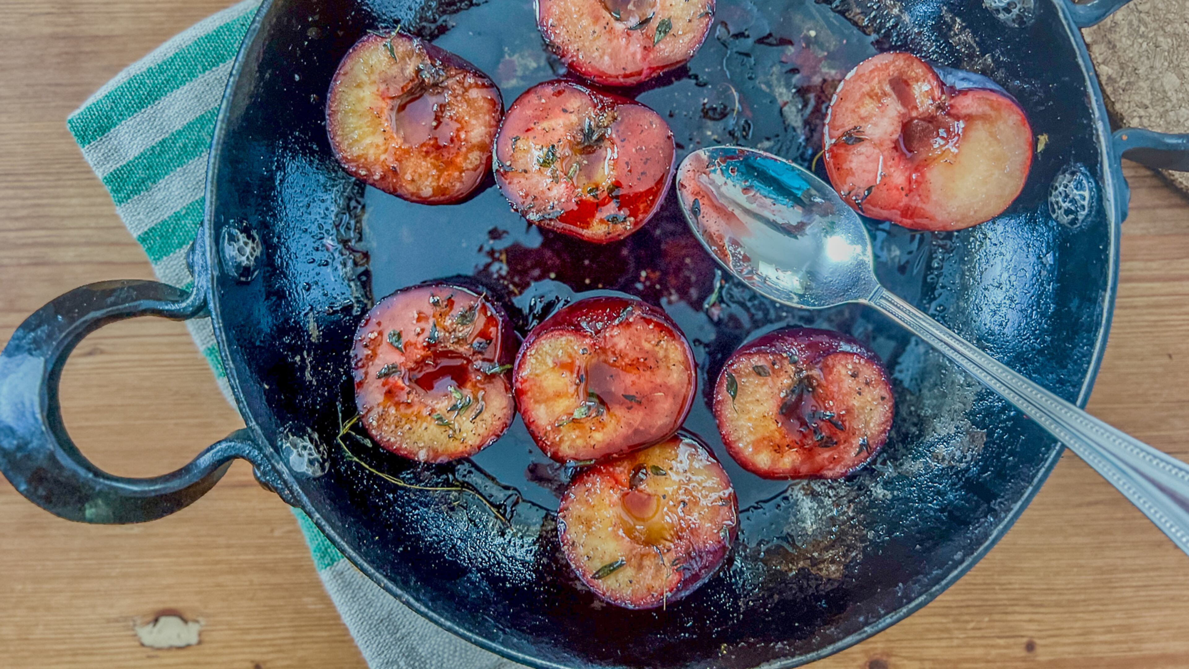 Baked plums with honey, herbs and spices make for a savory side dish. (Virginia Willis for The Atlanta Journal-Constitution)