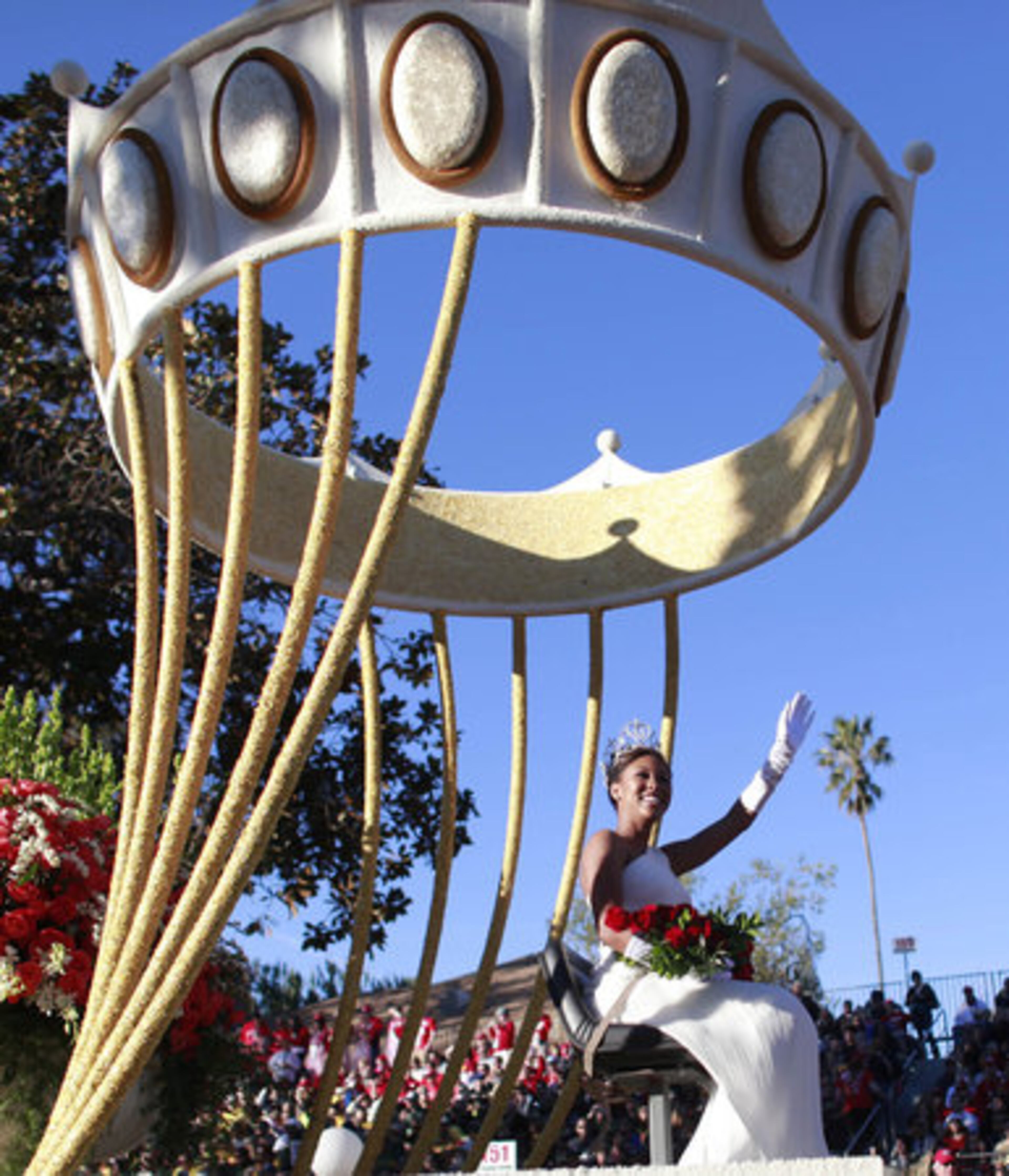 The 123rd Rose Parade queen, Drew Washington, waves to the crowd during the 123rd Rose Parade in Pasadena, California, on Monday, January 2, 2012.