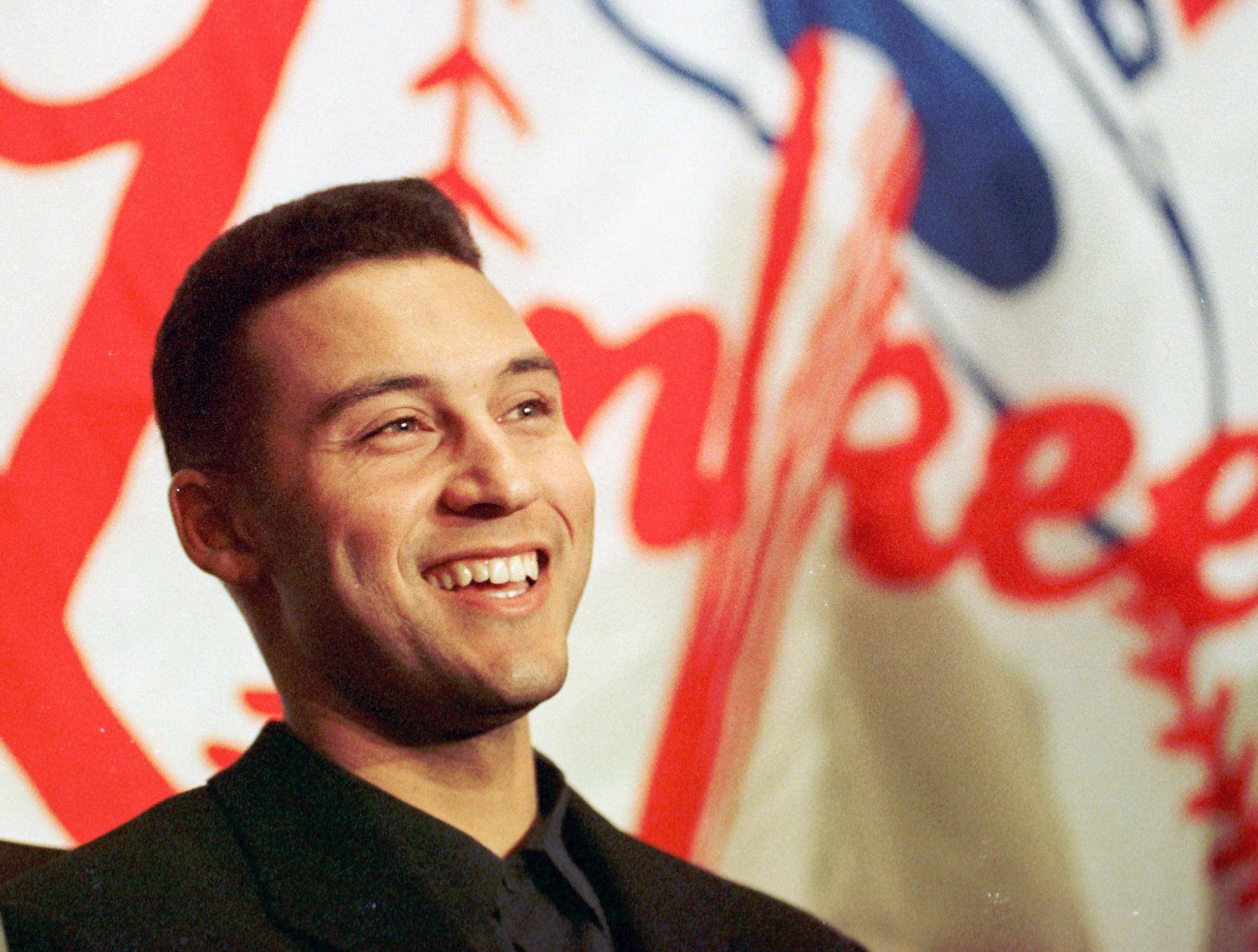 FILE - In this Nov. 4, 1996, file photo, New York Yankees shortstop Derek Jeter smiles during a news conference at Yankee Stadium in New York, after being named the American League winner of the Jackie Robinson Rookie of the Year Award for 1996 in balloting by the Baseball Writers' Association of America. Jeter has had as close to perfect a career as a major leaguer can have. Still, five years from now, don't expect the New York Yankees' captain to be a unanimous selection to baseball's Hall of Fame. (AP Photo/Ron Frehm, File)