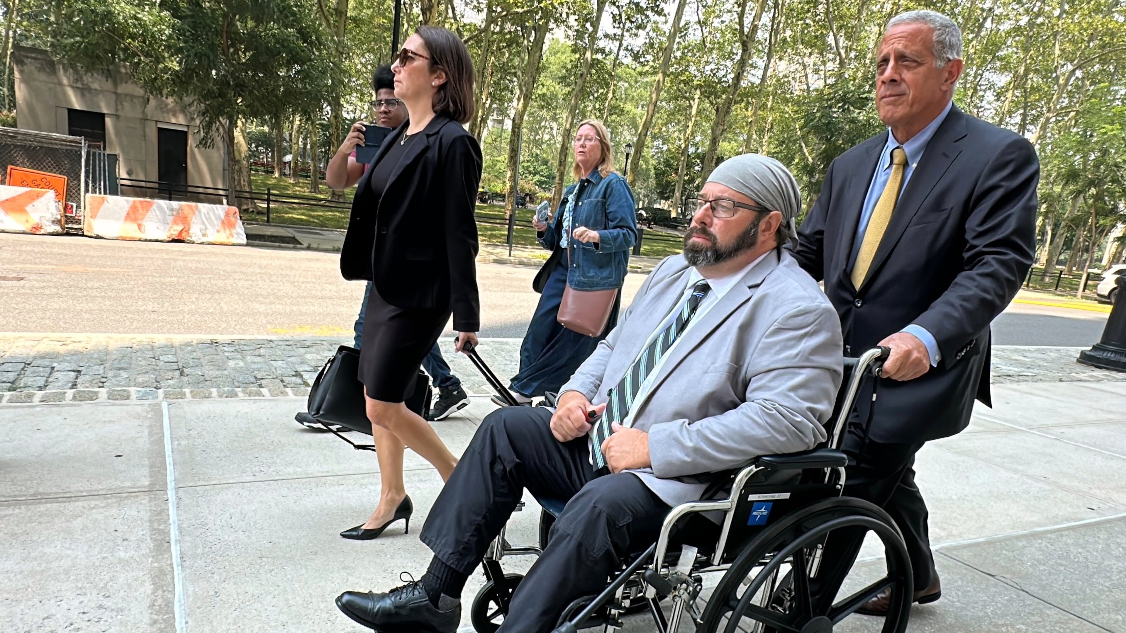 Former cargo ship captain John Merrone is wheeled out of federal court in the Brooklyn borough of New York by his lawyer, Bruce Barket, Wednesday, July 15, 2026, after pleading guilty to charges he drugged and sexually assaulted a U.S. Merchant Marine Academy cadet in 2019 while she was working on the vessel. (AP Photo/Michael R. Sisak)