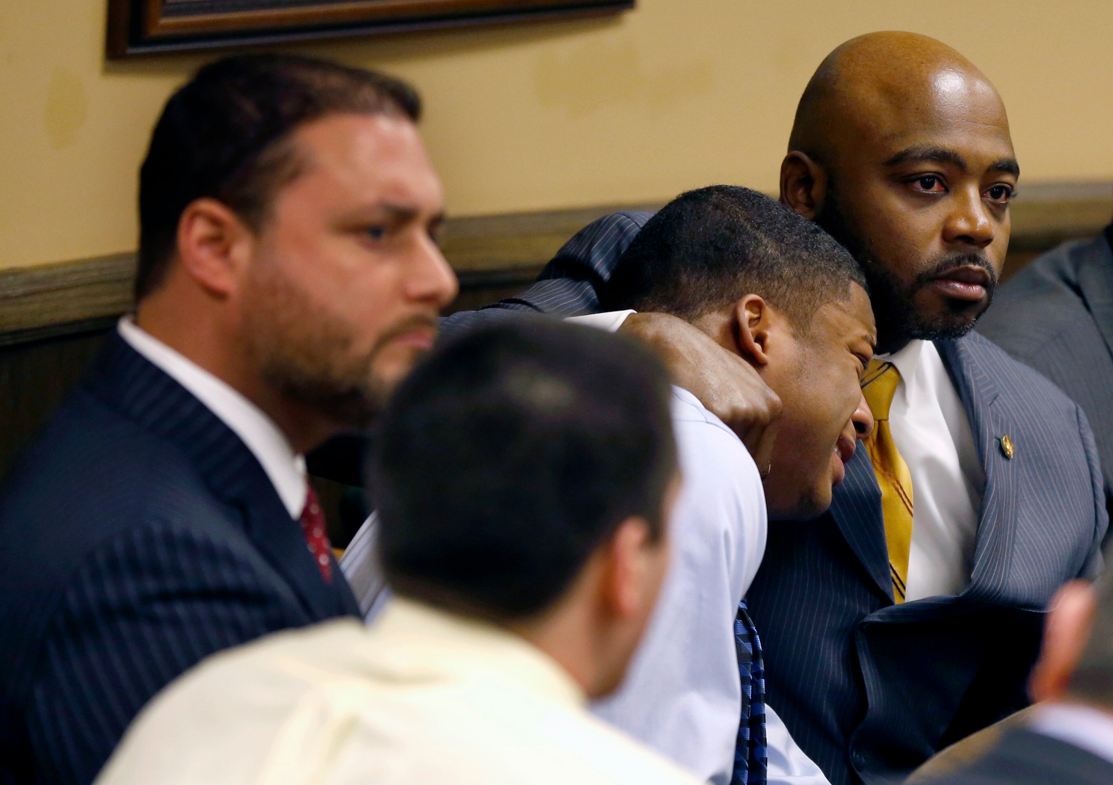 Defense attorney Walter Madison, right, holds his client, 16-year-old Ma'lik Richmond, second from right, while defense attorney Adam Nemann, left, sits with his client Trent Mays, foreground, 17, as Judge Thomas Lipps pronounces them both delinquent on rape and other charges after their trial in juvenile court in Steubenville, Ohio, Sunday. Mays and Richmond were accused of raping a 16-year-old West Virginia girl in August 2012.