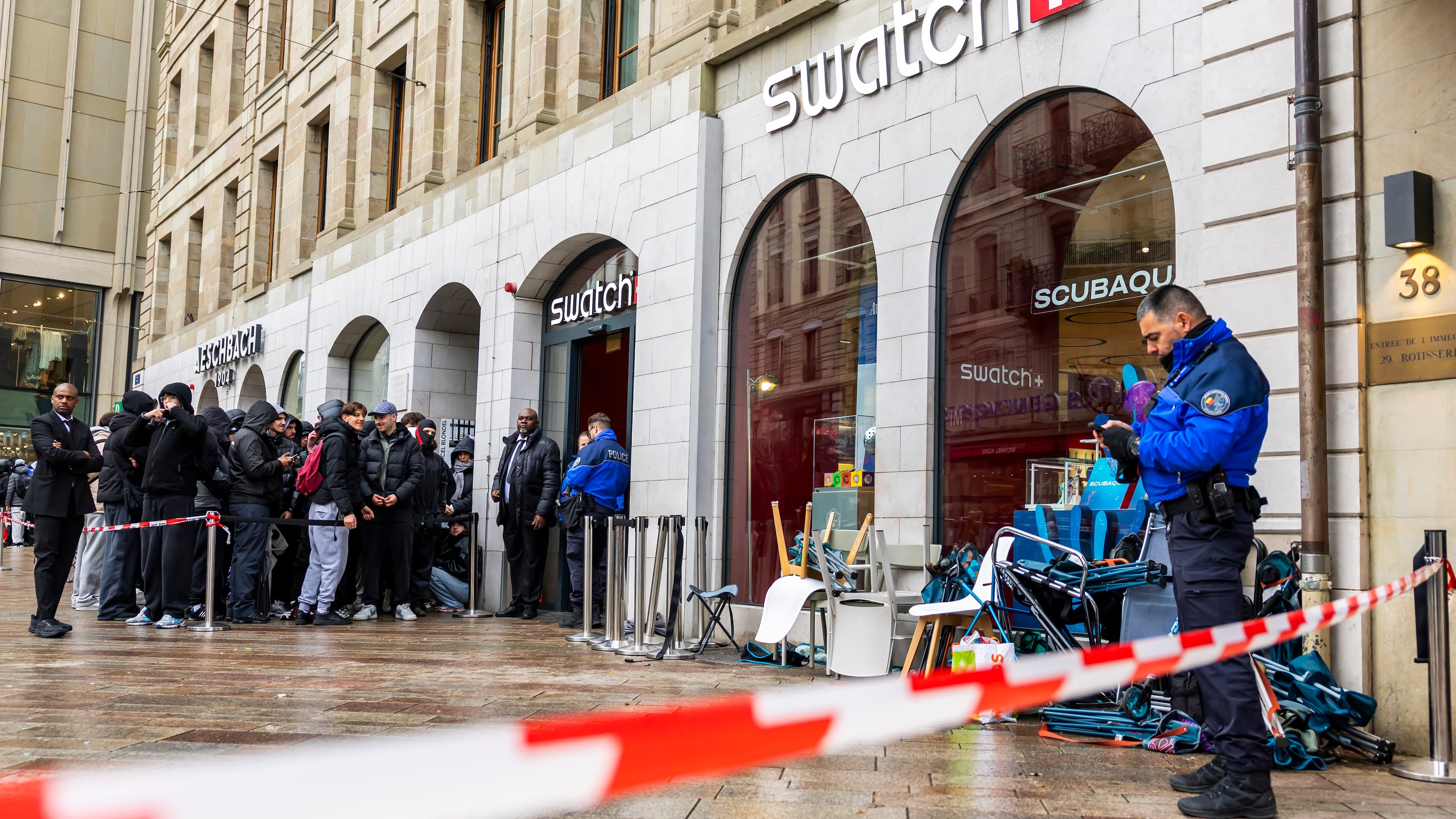 Swiss police officers secure the area where customers queue to buy the new Royal Pop watch by Swatch and Audemars Piguet, in Geneva, Switzerland, Saturday, May 16, 2026. (Salvatore Di Nolfi/Keystone via AP)