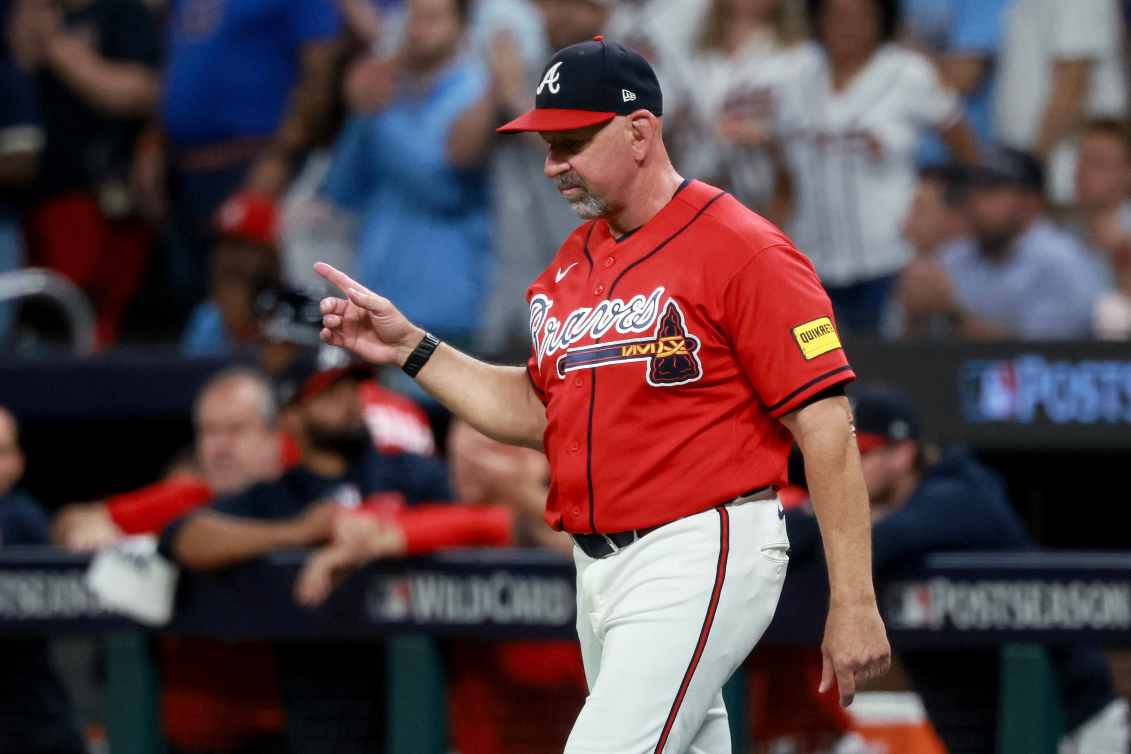 Atlanta Braves manager Walt Weiss (22) signals a pitching change against the Philadelphia Phillies during the fourth inning of Game 3 of a MLB National League Wild Card playoff series between the Atlanta Braves and the Philadelphia Phillies, Thursday, Oct. 1, 2026, in Atlanta. (Jason Getz/AJC)