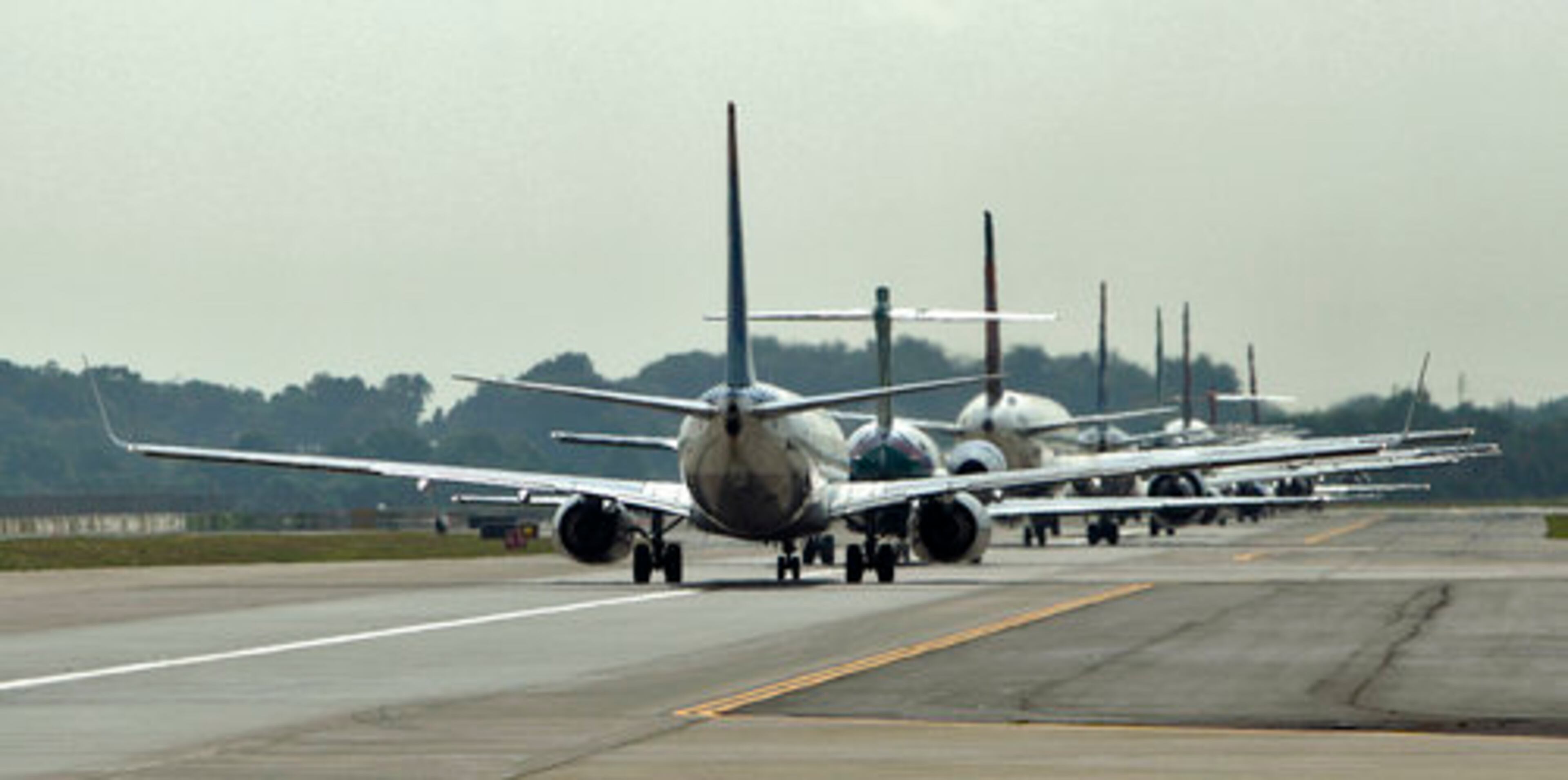Commercial flights stack up on the runway at Hartsfield-Jackson International Airport on Monday, July 12, ahead of the Georgia Skies morning flight to Macon. After Delta Connection pulled its Macon flights and the new federally-subsidized carrier Georgia Skies started, passenger traffic on the route dropped significantly.