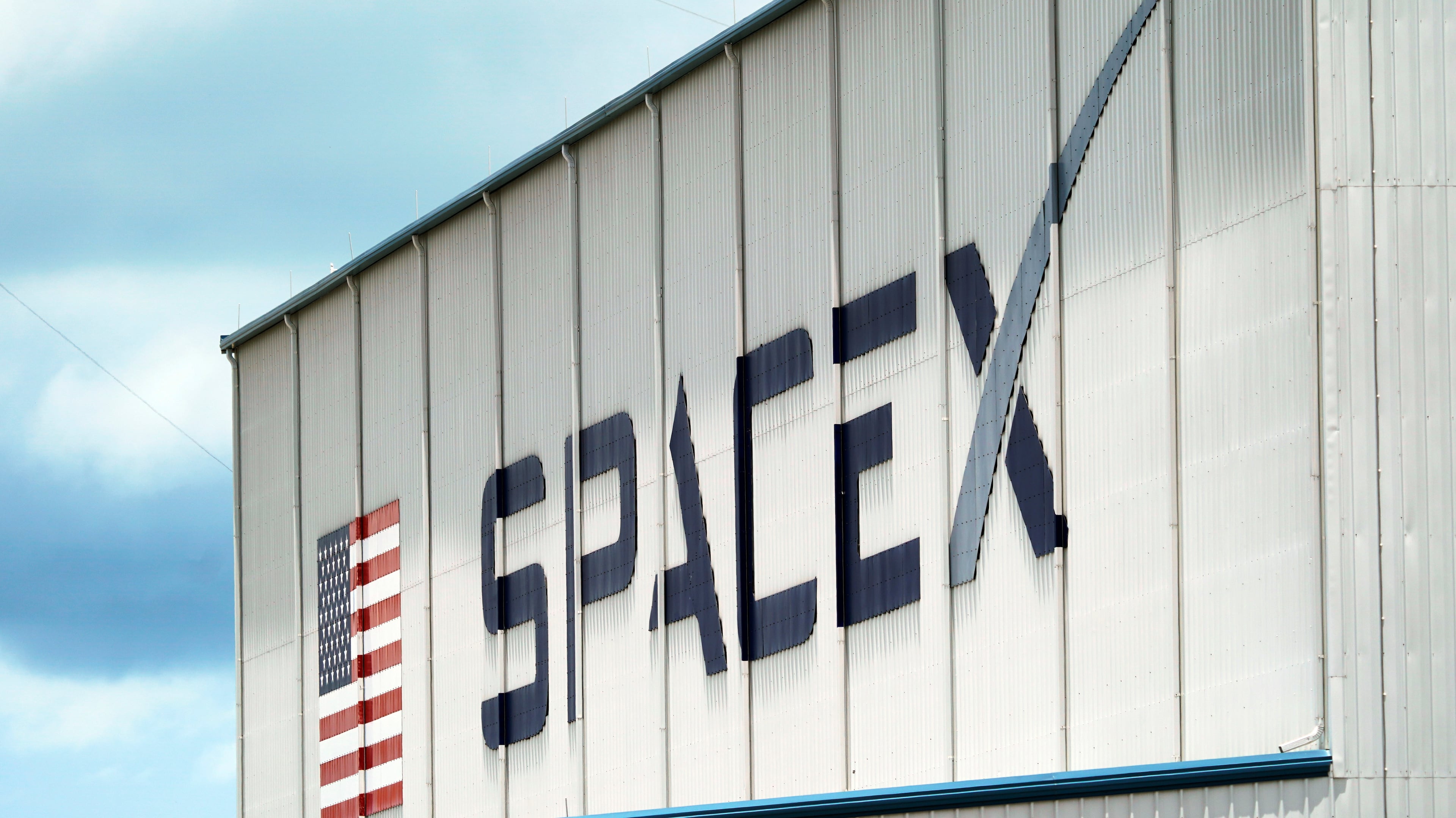 FILE - A SpaceX logo is displayed on a building, May 26, 2020, at the Kennedy Space Center in Cape Canaveral, Fla. (AP Photo/David J. Phillip, File)
