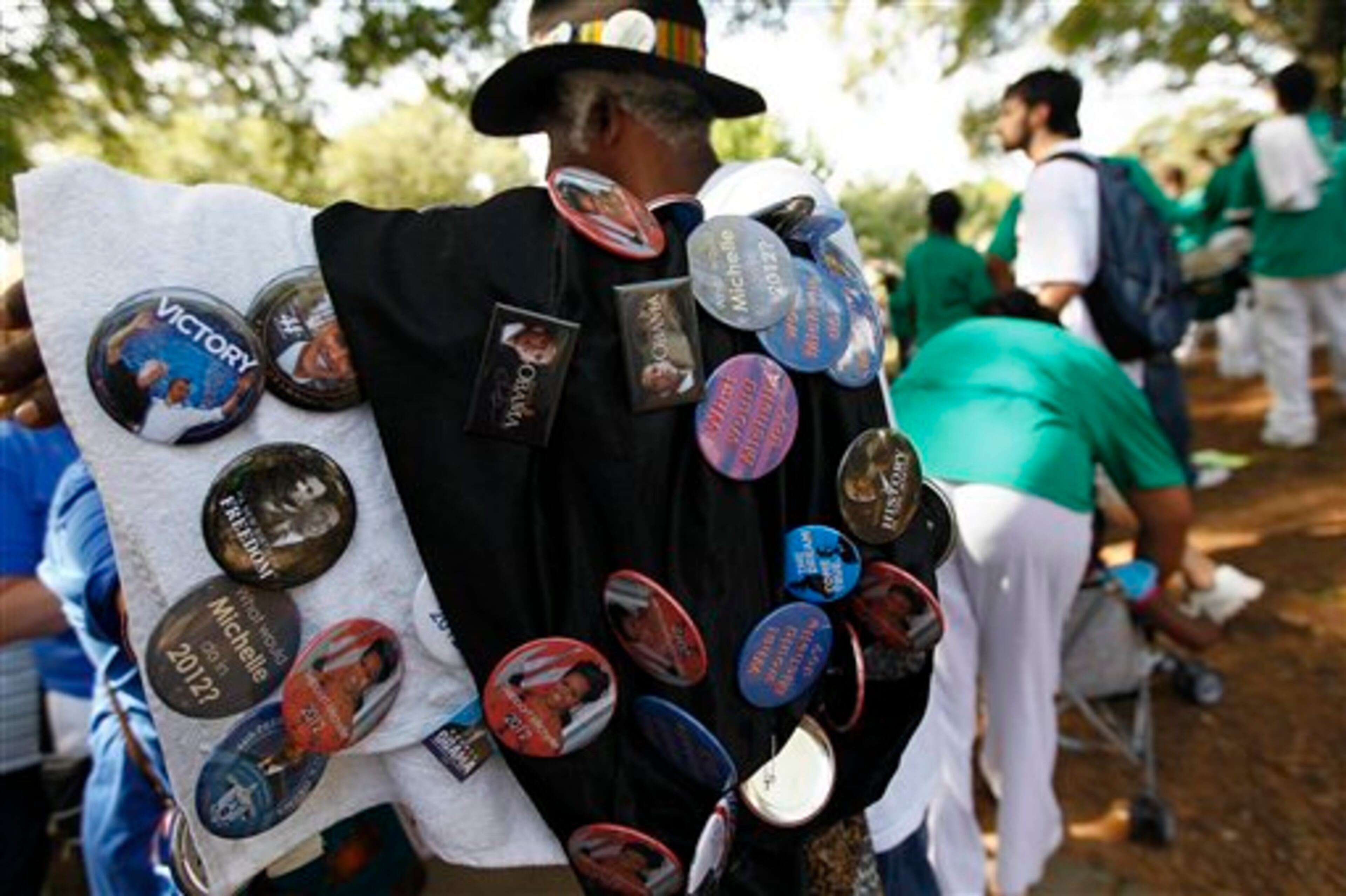 A vendor sells political buttons, Monday, Sept. 3, 2012, in Charlotte, N.C. Demonstrators are protesting before the start of the Democratic National Convention. (AP Photo/Gerry Broome)