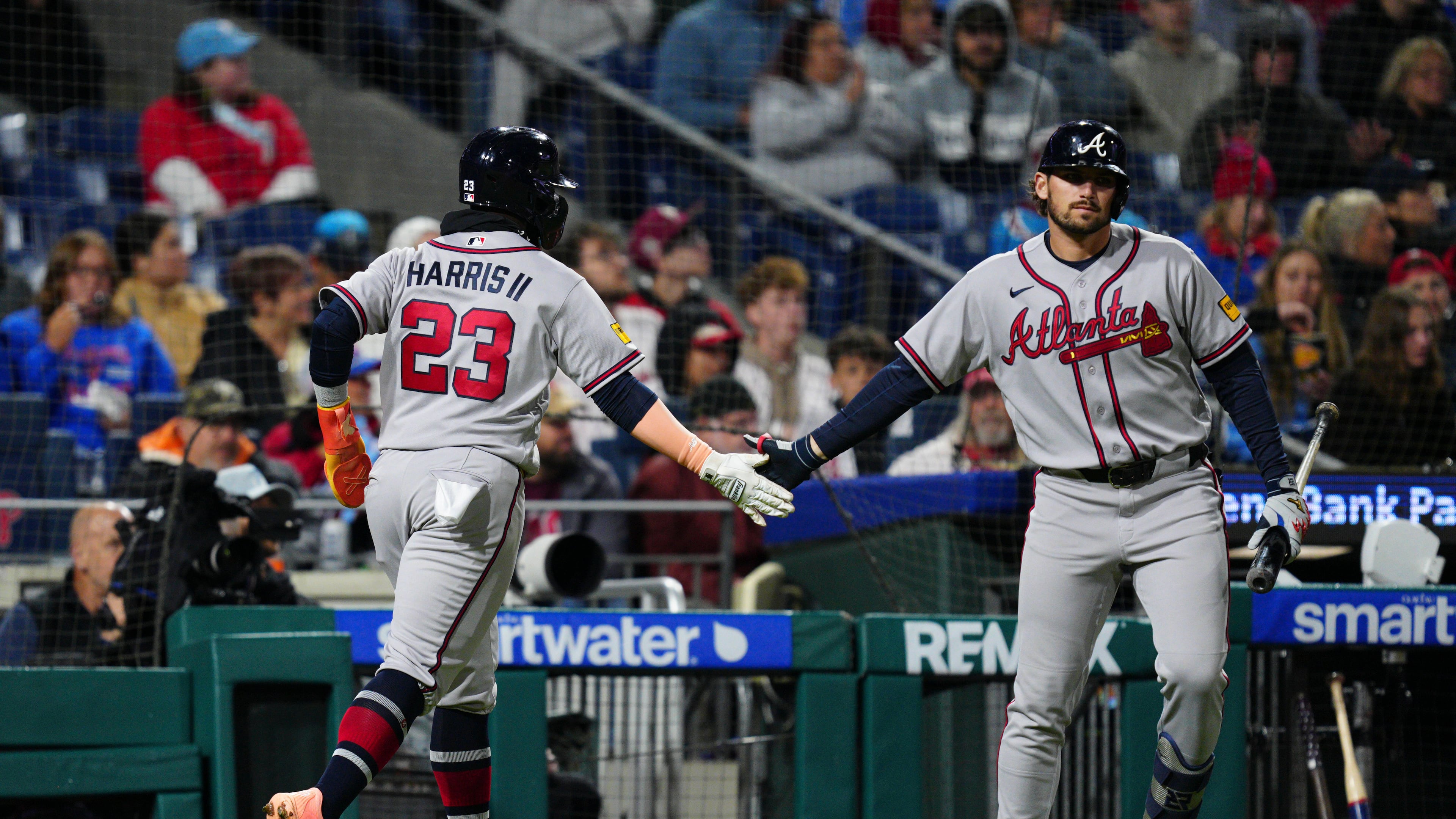 Atlanta Braves' Michael Harris II (23) celebrates with Austin Riley, right, after scoring during the fifth inning of a baseball game against the Philadelphia Phillies, Sunday, April 19, 2026, in Philadelphia. (AP Photo/Derik Hamilton)