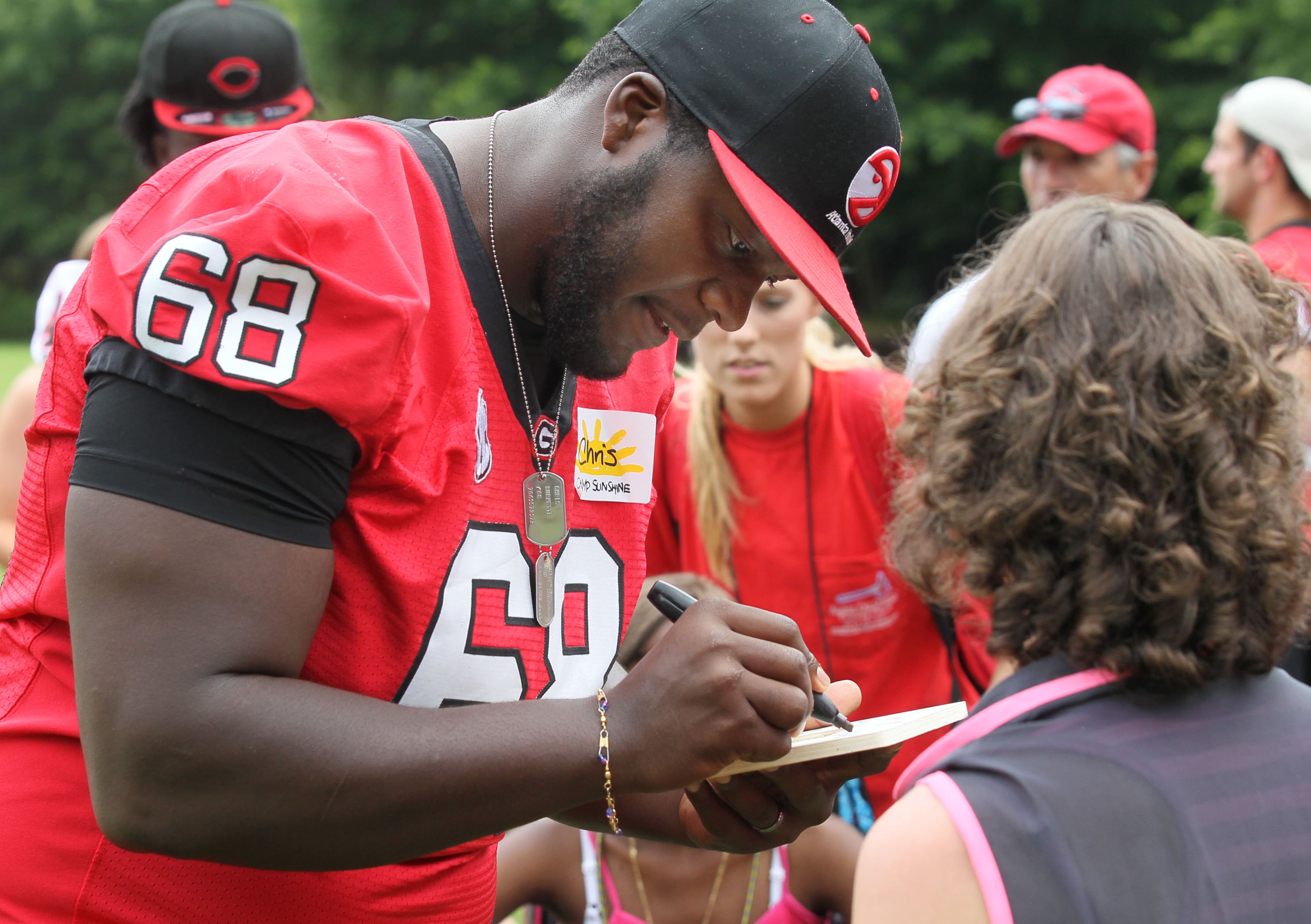 UGA football player Chris Burnette signs an autograph.