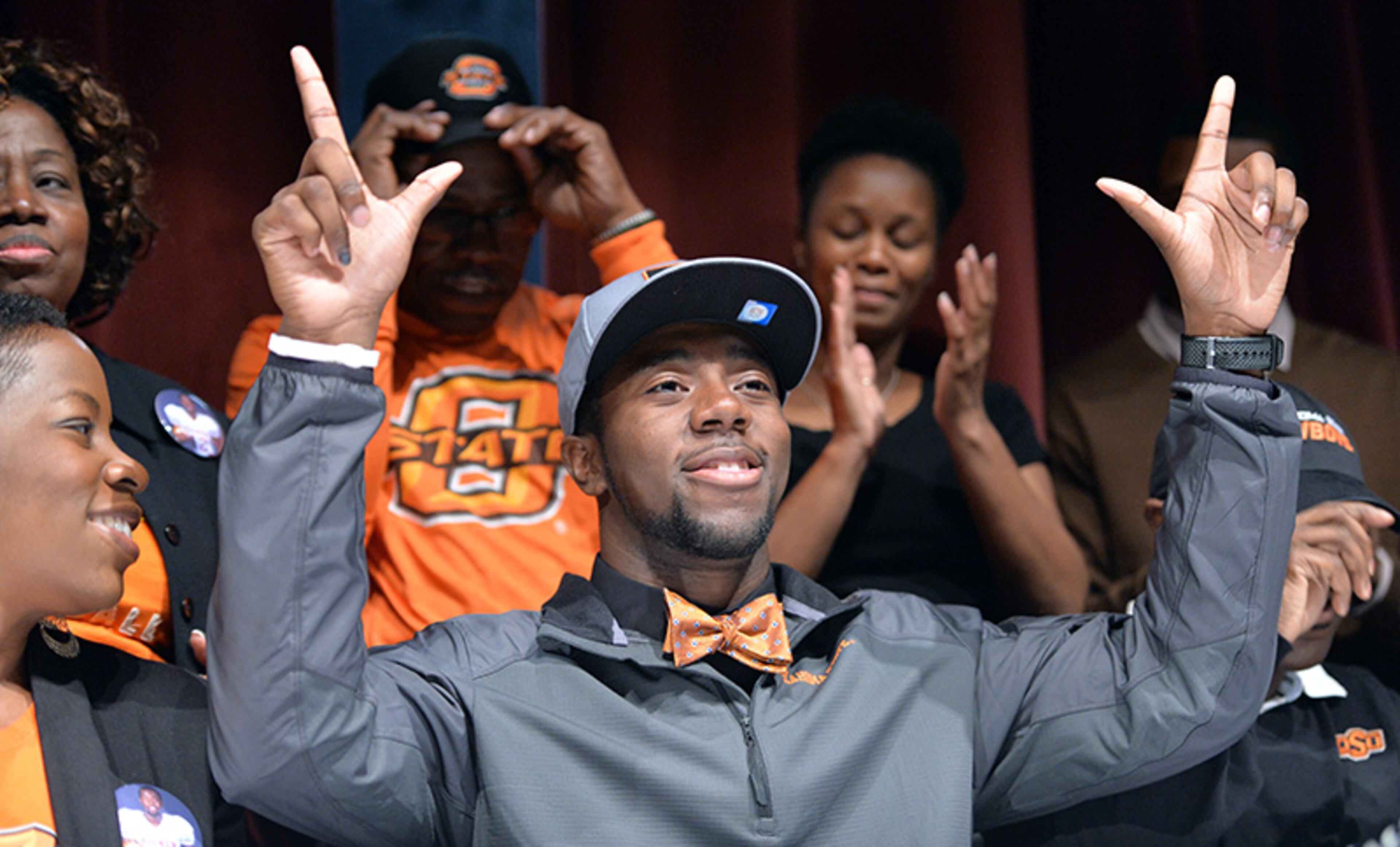 Kirk Tucker celebrates after he signed with Oklahoma State during signing day at Tucker High School.