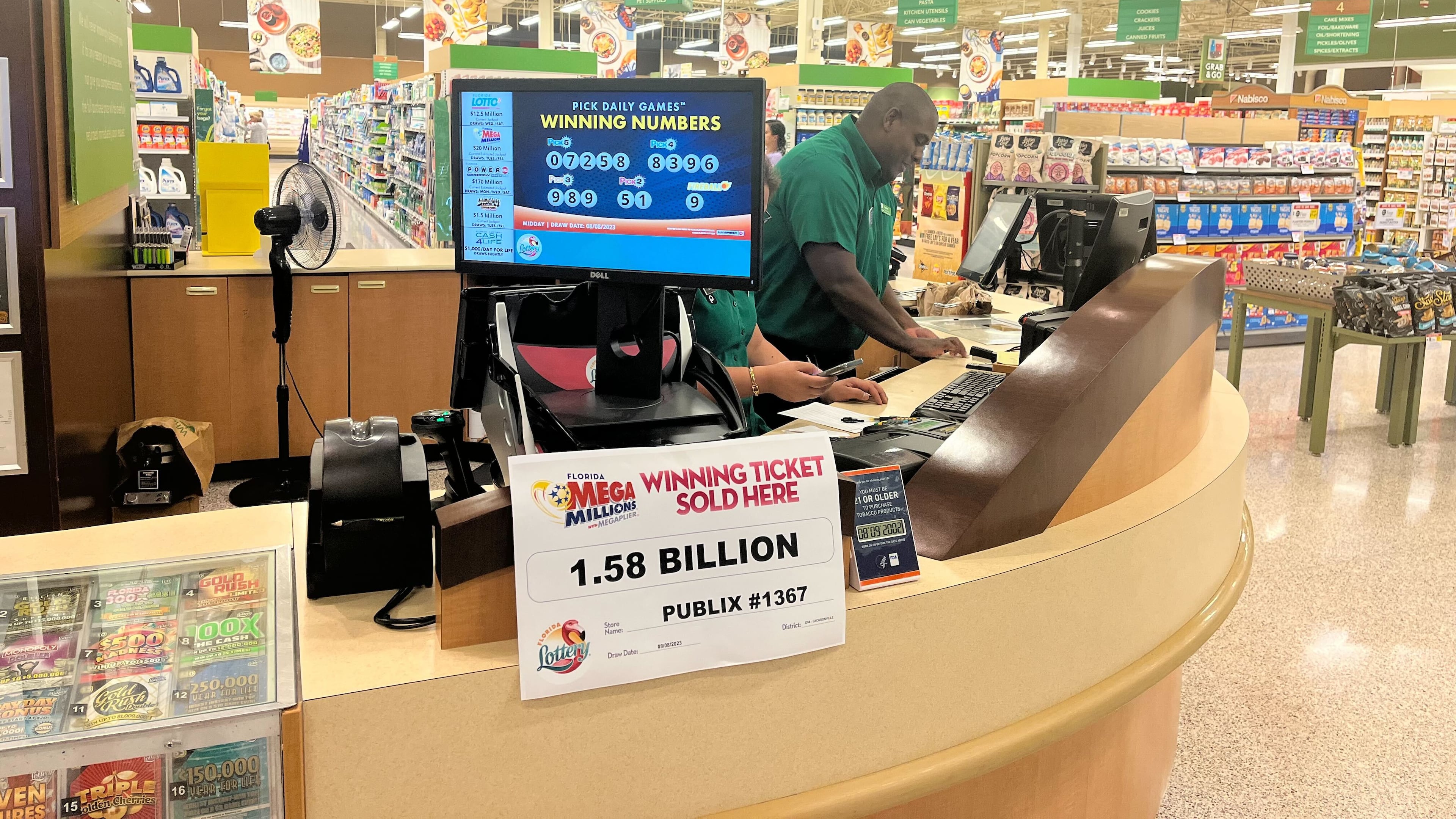 A sign announcing the $1.58 billion winning ticket sits on the counter inside a Publix in Neptune Beach, Florida, on Wednesday morning.
