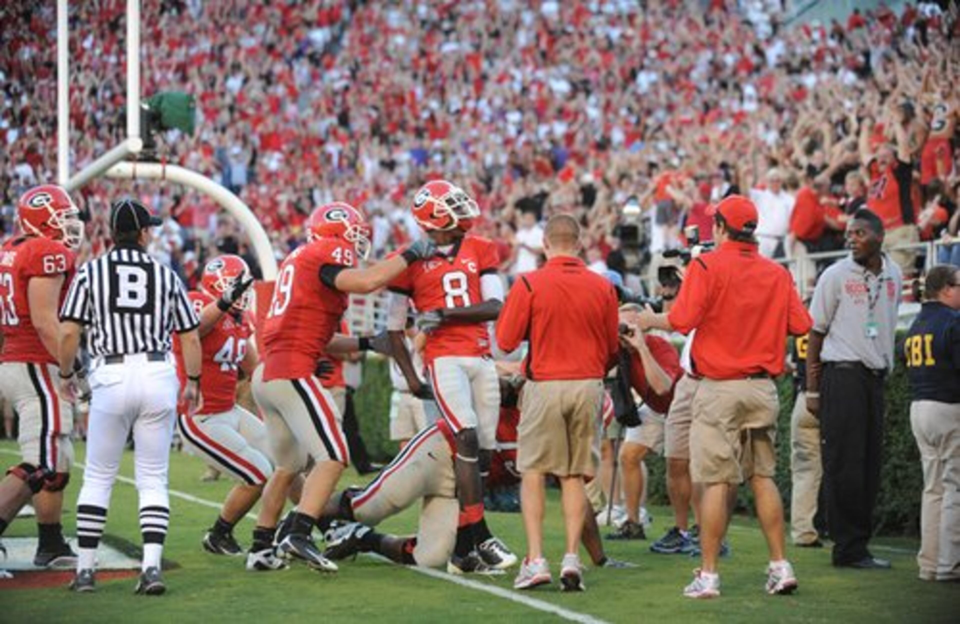 Green (8), according to officials, walks away from teammates and makes a gesture to the crowd calling attention to himself, drawing a personal foul for excessive celebration from back judge Michael Watson (left).