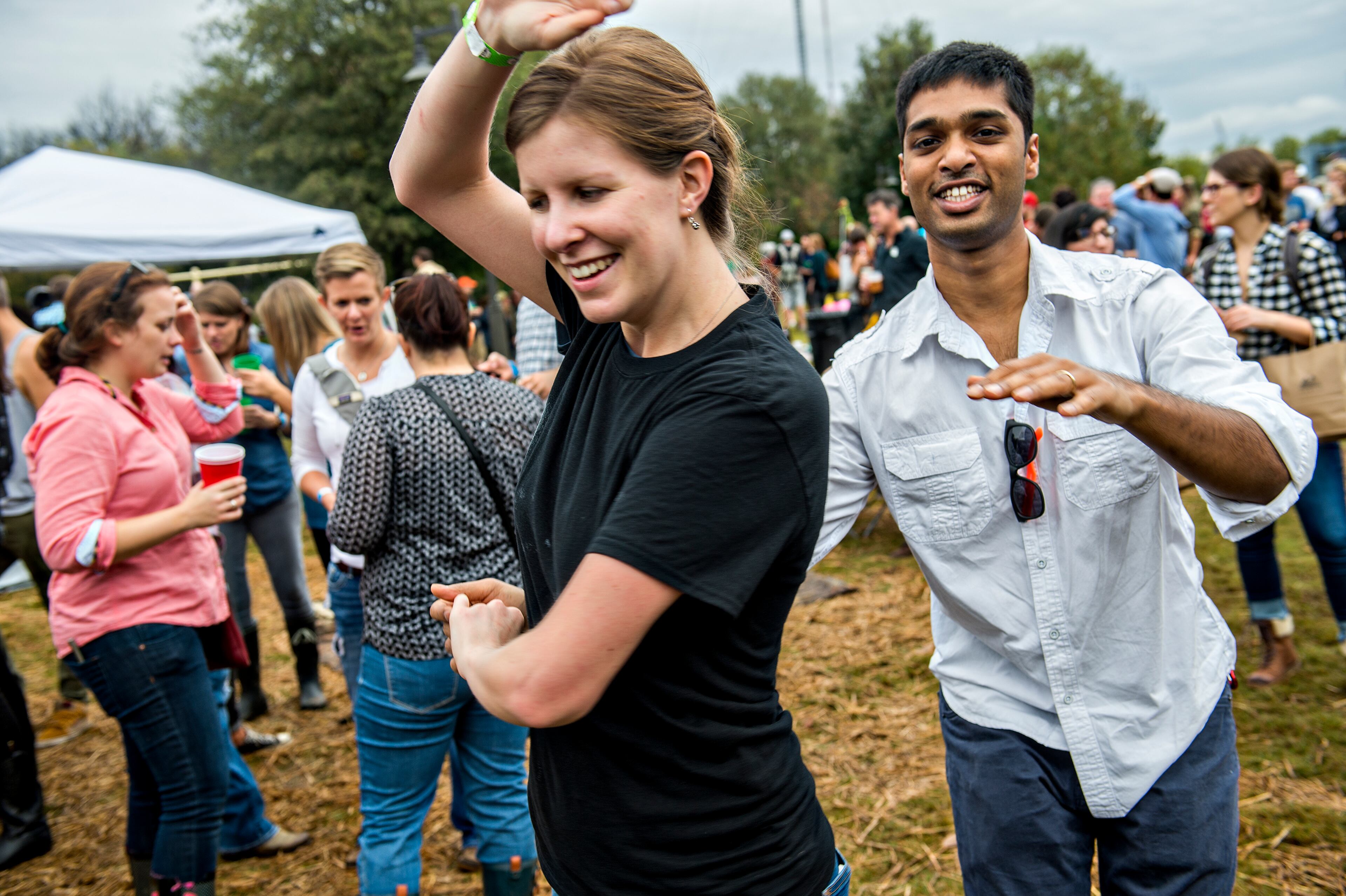 Margaret Tilson (left) dances with Kishore Devisetti during the Cabbagetown Chomp & Stomp in Atlanta on Saturday, November 7, 2015. Thousands of people took over the streets of the neighborhood to eat, drink, shop, listen to music and particiapte in cabbage related games. JONATHAN PHILLIPS / SPECIAL