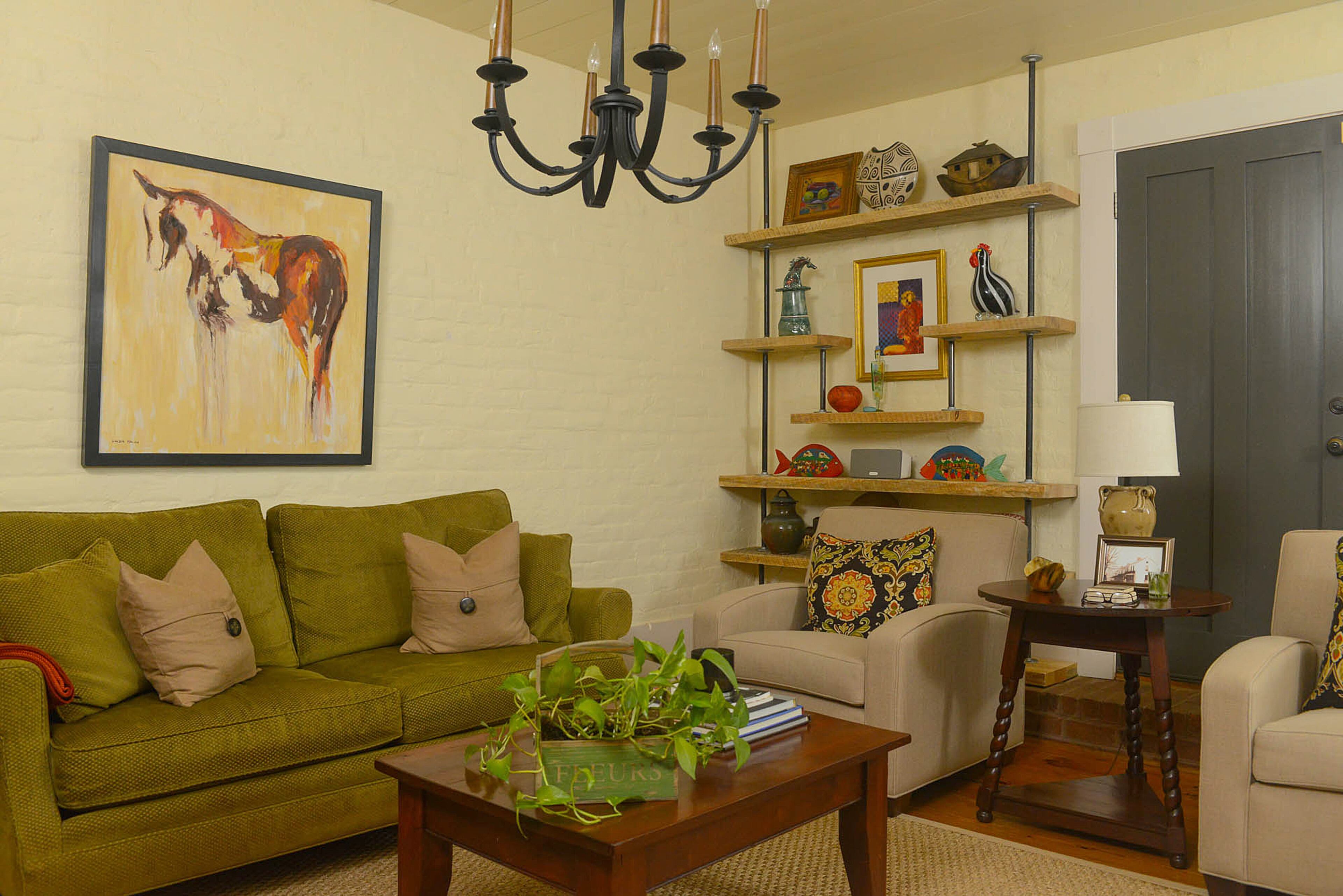 Dee designed the living room sofa and covered it with fabric from Lewis & Sheron Textiles. Many of her furnishings have a traditional style, although some pieces, such as the open bookshelf, have a rustic touch.