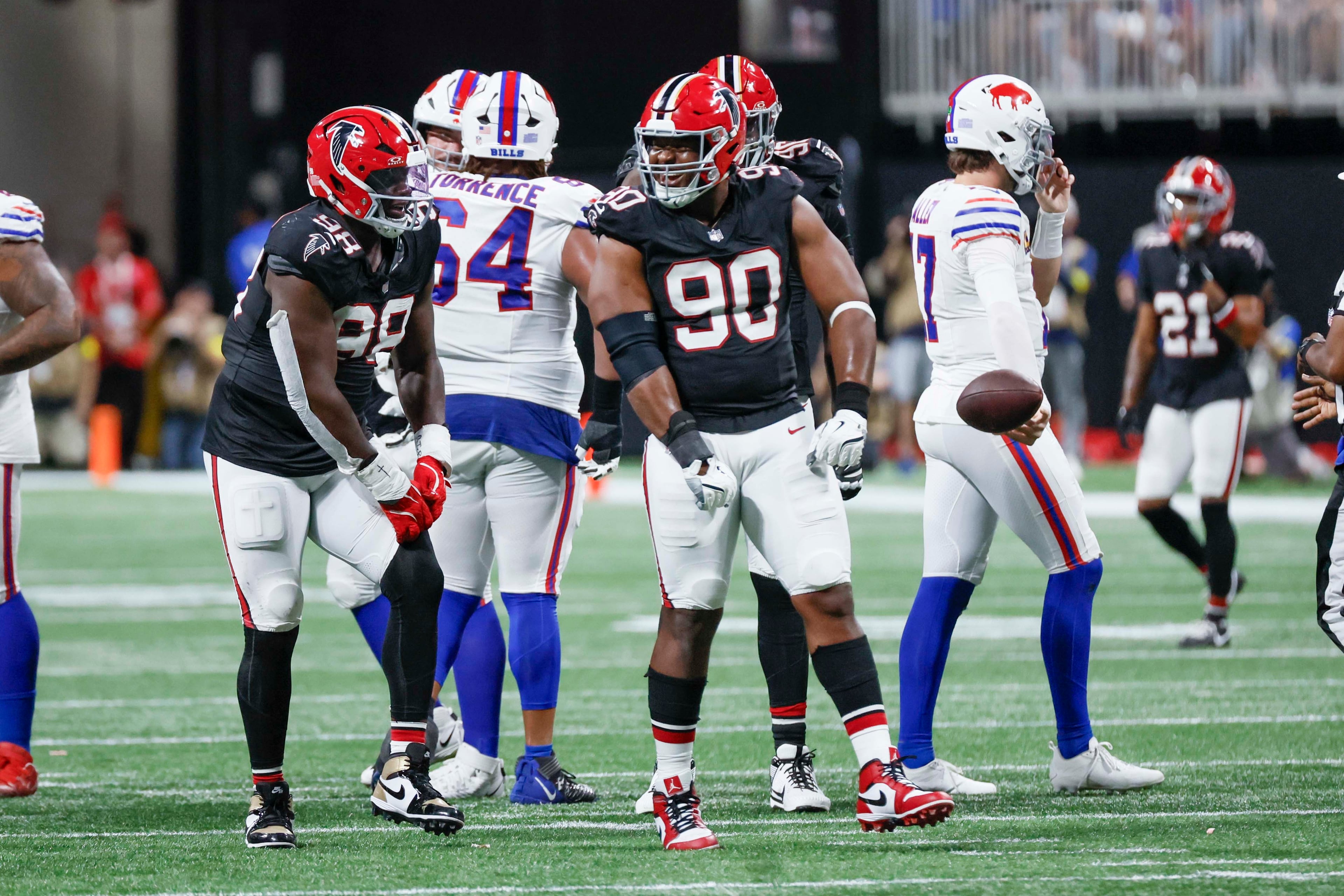 Atlanta Falcons defensive tackle David Onyemata (90) celebrates with teammate Ruke Orhorhoro (98) after sacking Buffalo Bills quarterback Josh Allen (17) during the second half at Mercedes-Benz Stadium in Atlanta on Monday, October 13, 2025.
(Miguel Martinez/ AJC)