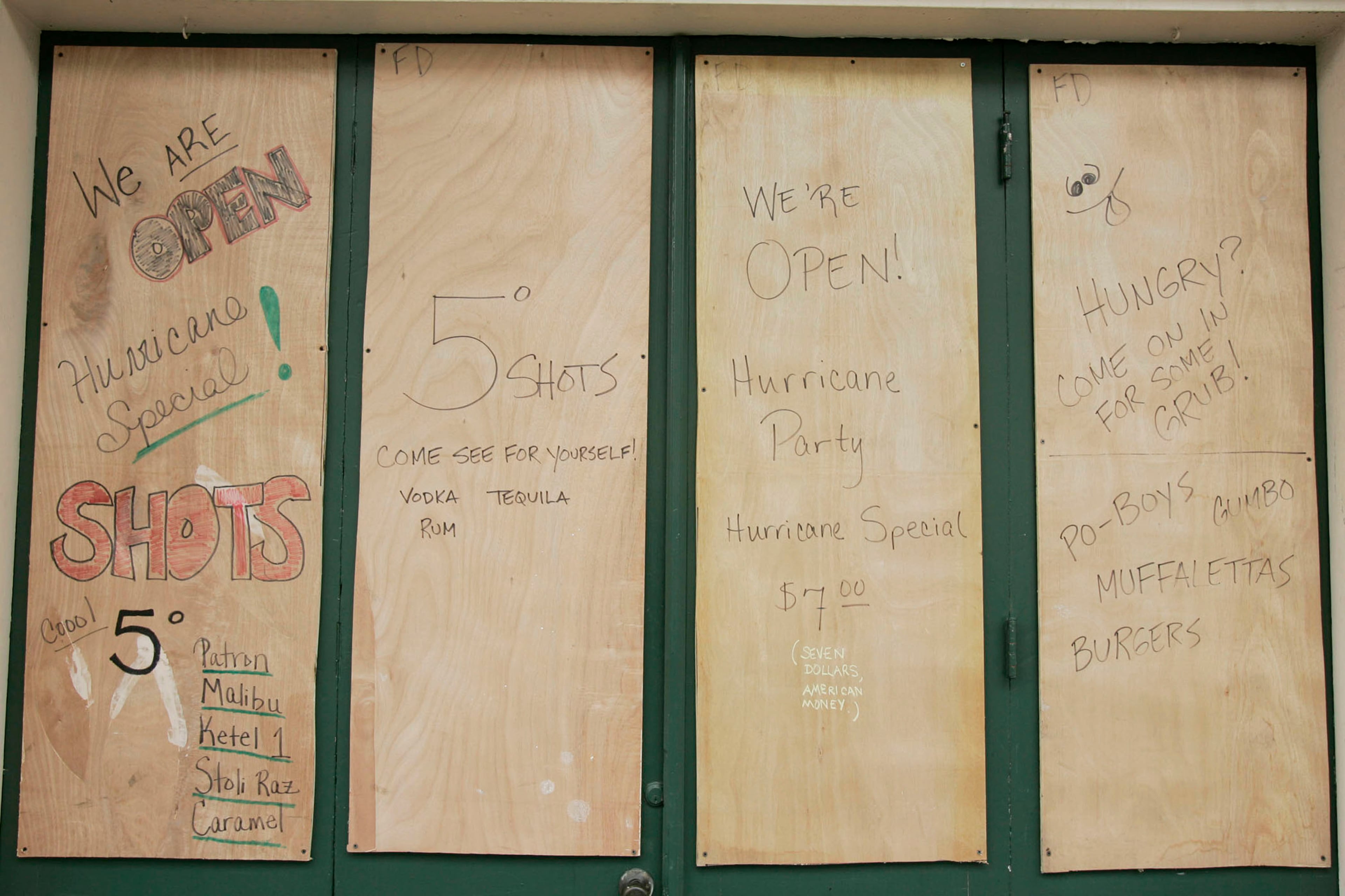 Hurricane specials are displayed on a boarded-up French Quarter bar ahead of Hurricane Katrina August 28, 2005 in New Orleans, Louisiana. The storm is expected to make landfall in the morning of August 29. (Photo by Chris Graythen/Getty Images)