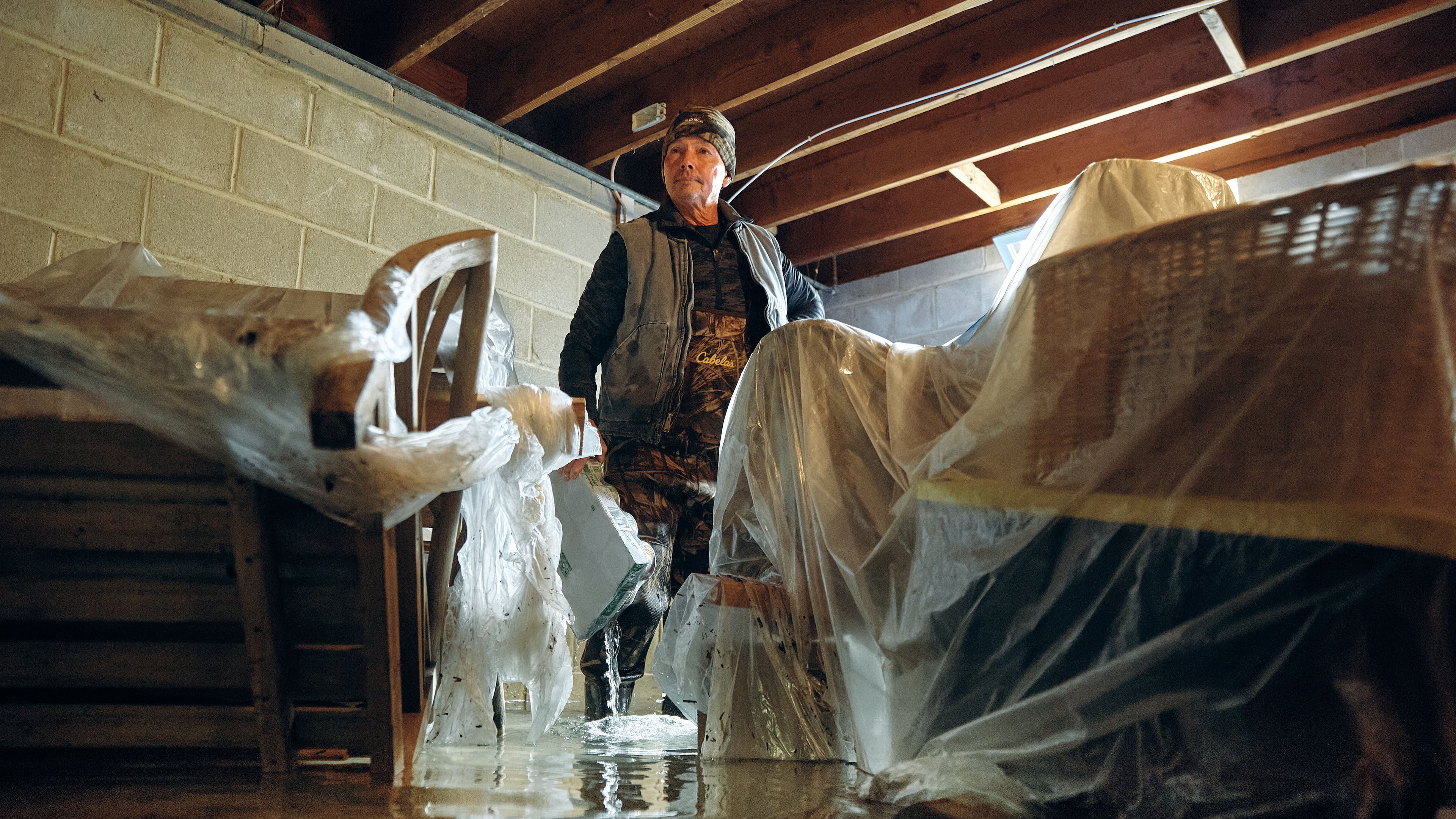 Bernard Dowd checks his flooded basement during a nor'easter on Sunday, Sept. 27, 2026, in Sea Bright, N.J. (AP Photo/Andres Kudacki)