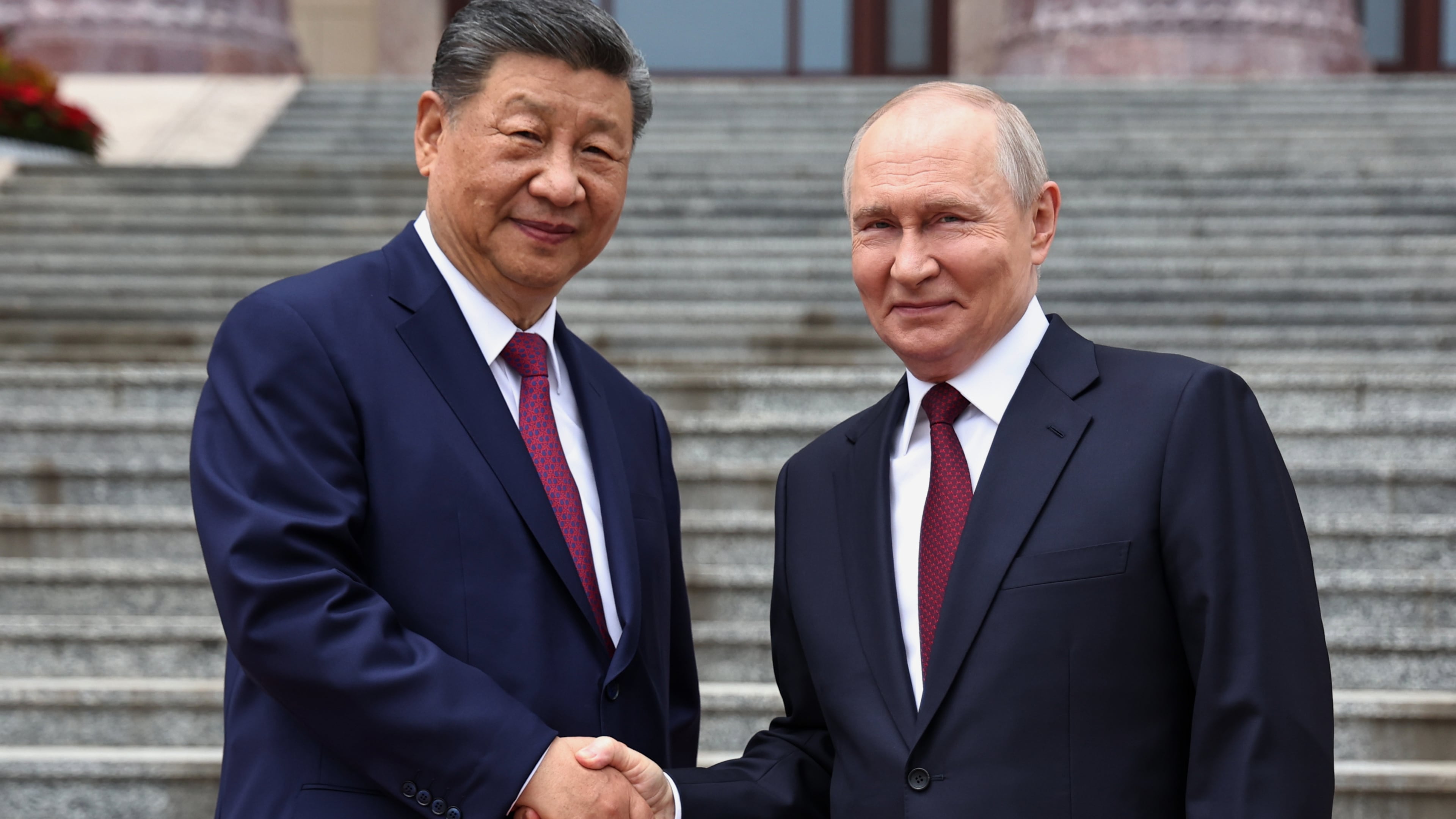 Russian President Vladimir Putin, right, and Chinese President Xi Jinping shake hands during a welcome ceremony at the Great Hall of the People, in Beijing, China, on Wednesday, May 20, 2026. (Alexander Kazakov, Sputnik, Kremlin Pool Photo via AP)