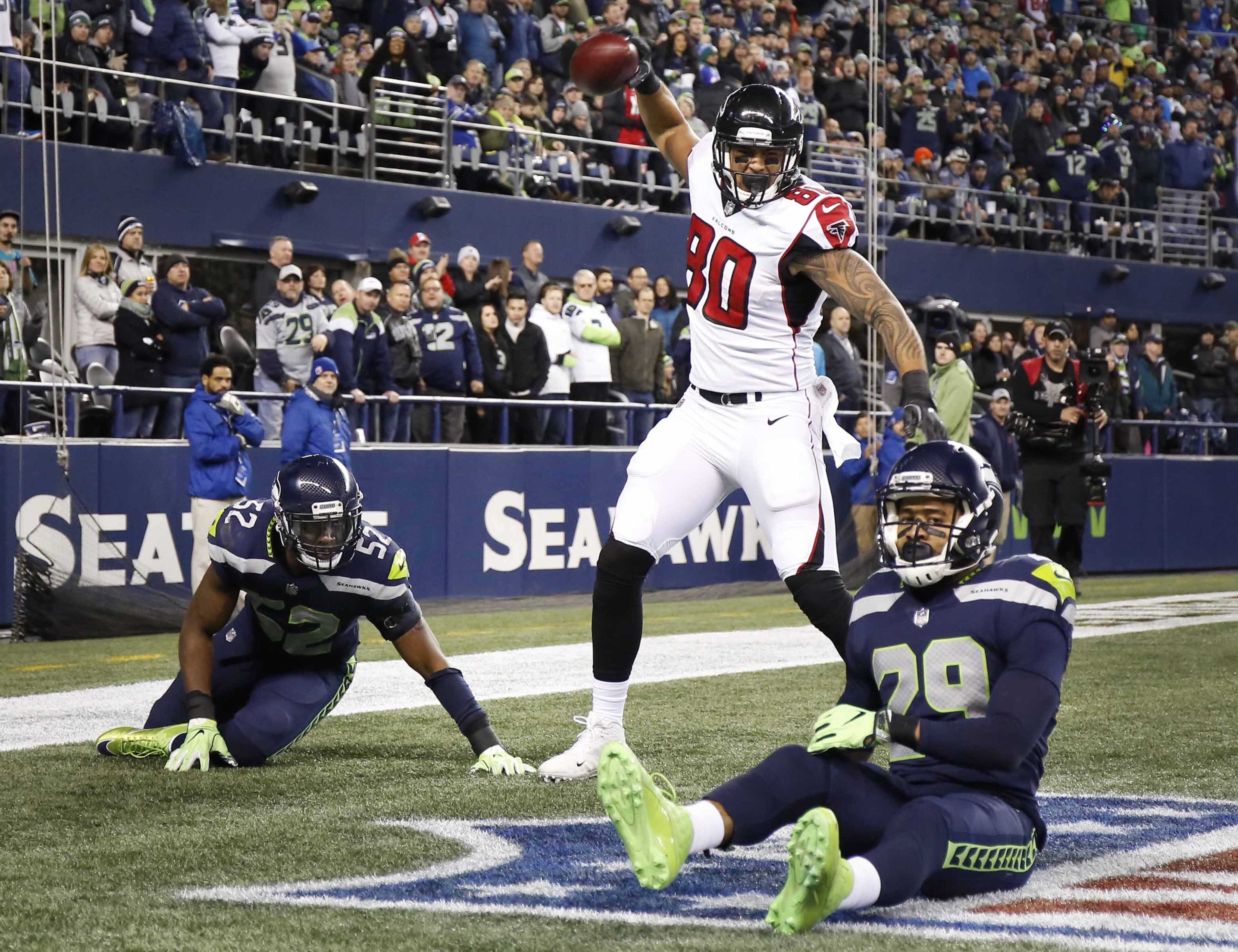 SEATTLE, WA - NOVEMBER 20: Tight end Levine Toilolo #80 of the Atlanta Falcons spikes the ball to celebrate his 25 yard touchdown as linebacker Terence Garvin #52 of the Seattle Seahawks and Earl Thomas #29 react during the third quarter of the game at CenturyLink Field on November 20, 2017 in Seattle, Washington. (Photo by Otto Greule Jr/Getty Images)