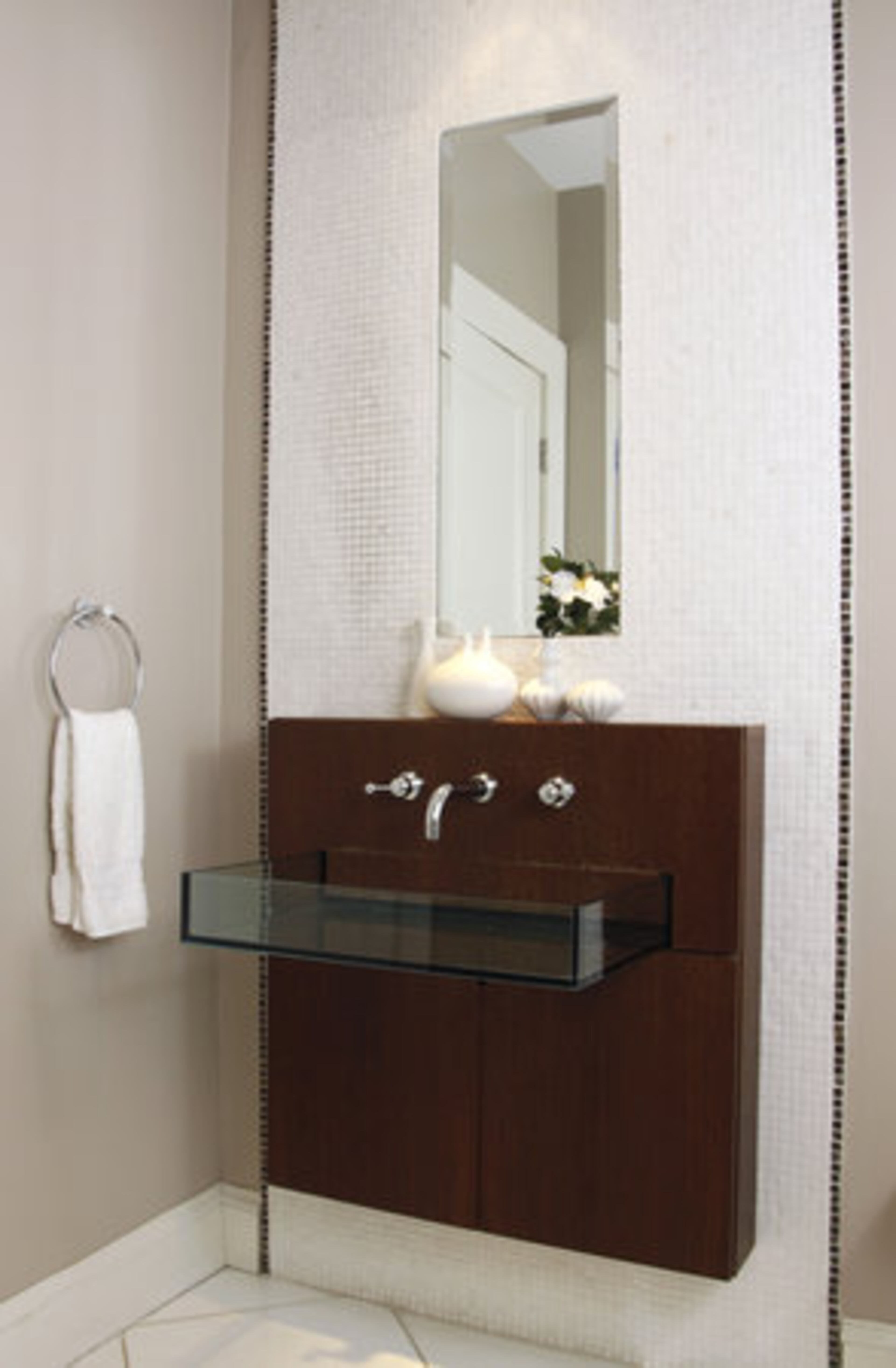 This guest bathroom goes modern with its sleek sink and vanity combination.