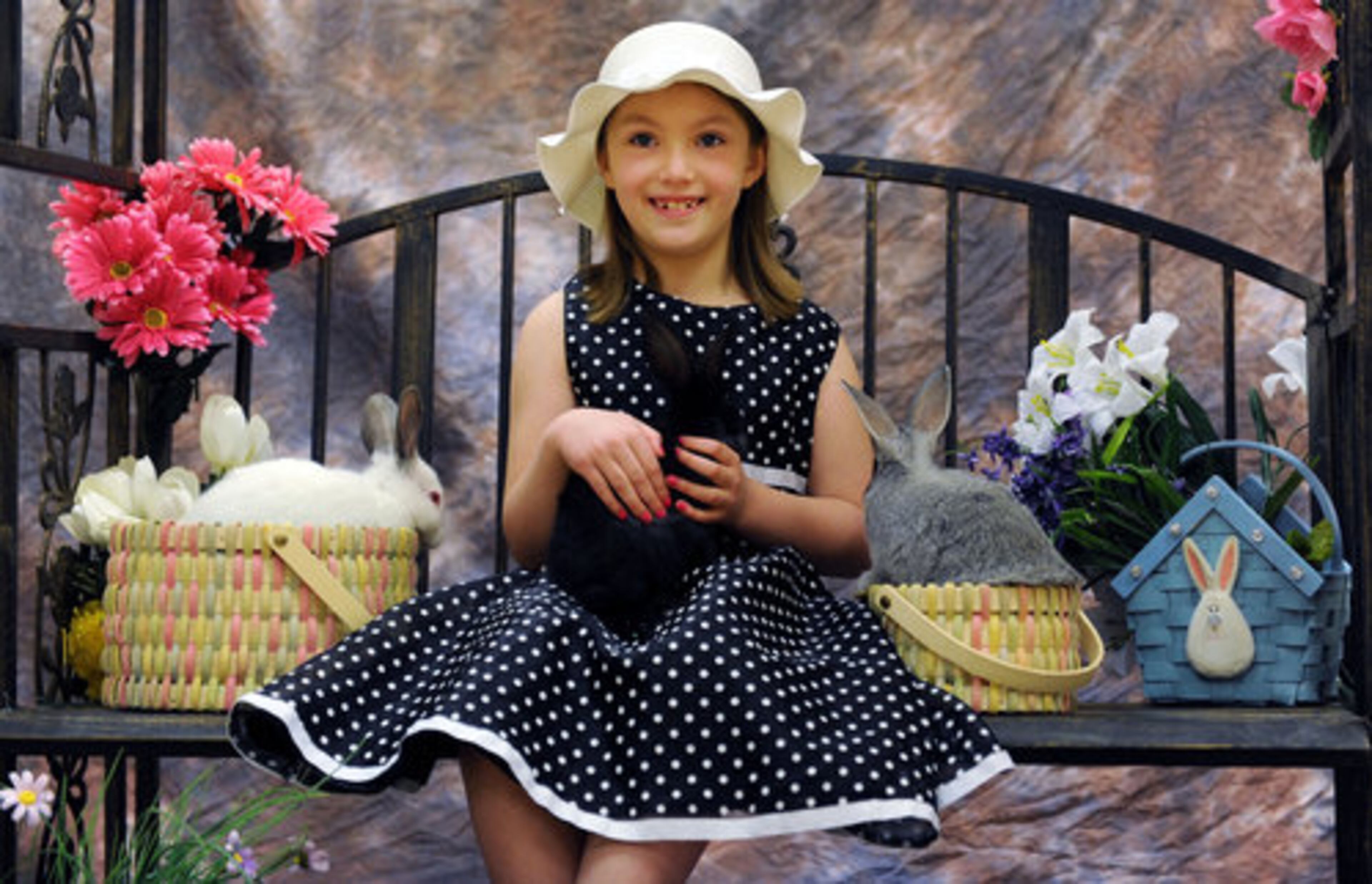 Samantha Burrell, 7, has her photo taken with live bunnies in advance of Easter at the Learning Express in Alpharetta Saturday, April 9, 2011. This is the fourth year in a row Burrell is having her picture taken with bunnies. Some parents are choosing to have their children pose with live bunnies versus a human in a furry costume for Easter portraits.