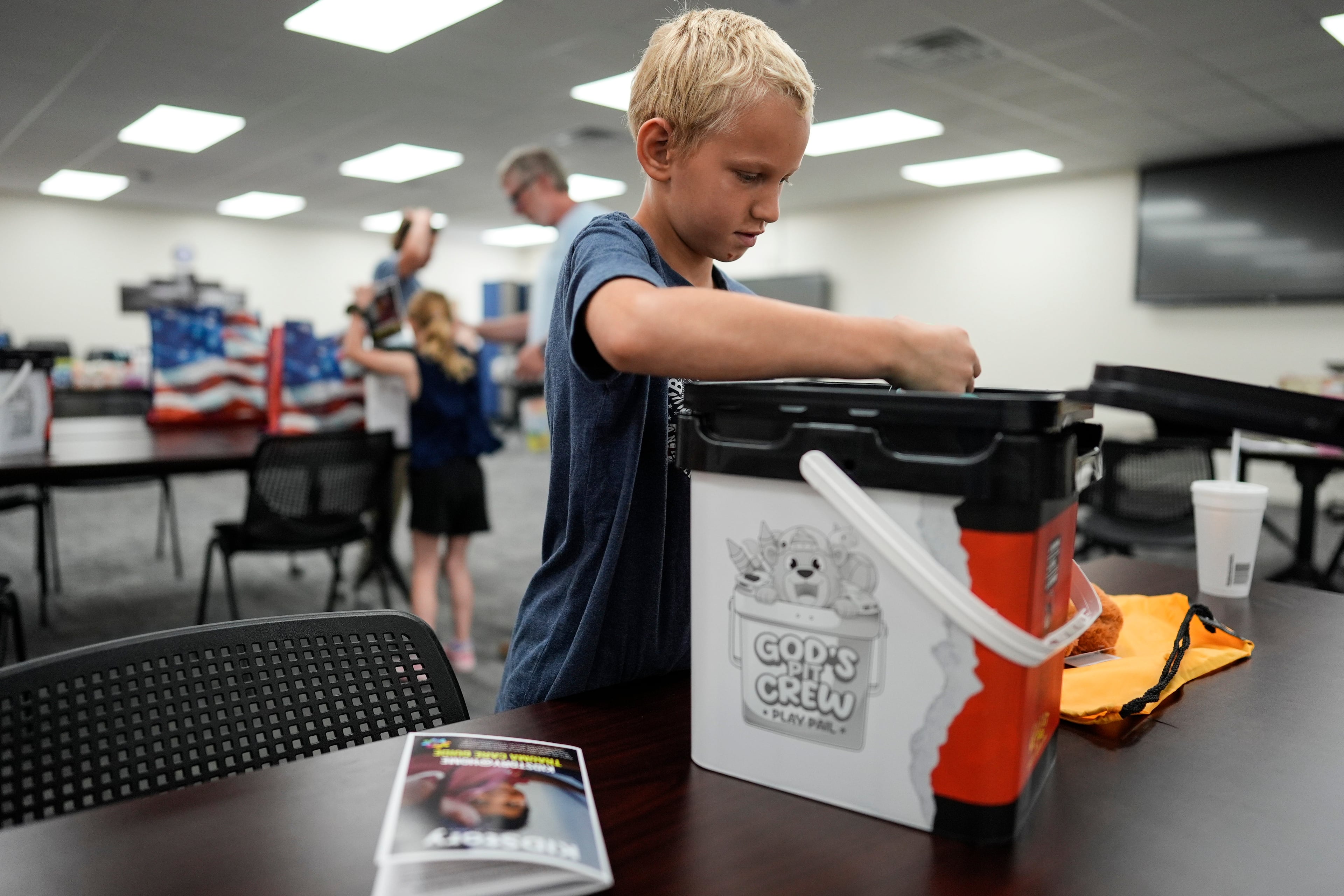 Marshall Latham goes through supplies he received at the Brantley County Schools transportation department during the Brantley Highway 82 fire, Friday, April 24, 2026, in Nahunta, Ga. The family lost thier home in the fire Monday. (Mike Stewart/AP)