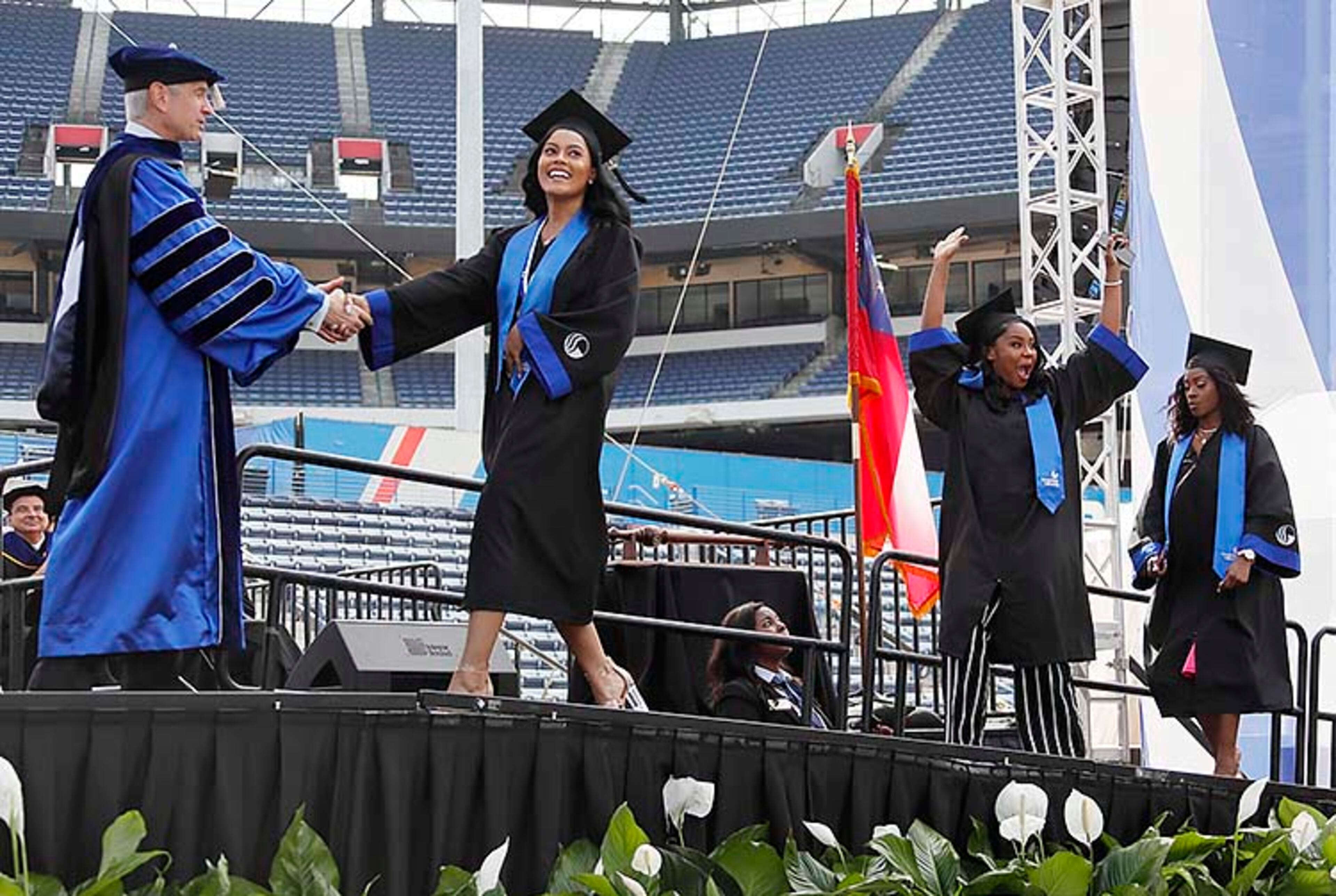 May 9, 2019 - Atlanta - Graduates react in different ways as they take the stage to get their diplomas. Georgia State University is hosting its 104th Commencement Monday, May 6 through Tuesday, May 14 at Panther Stadium in Atlanta. Six schools held their graduation on Thursday. Bob Andres / bandres@ajc.com