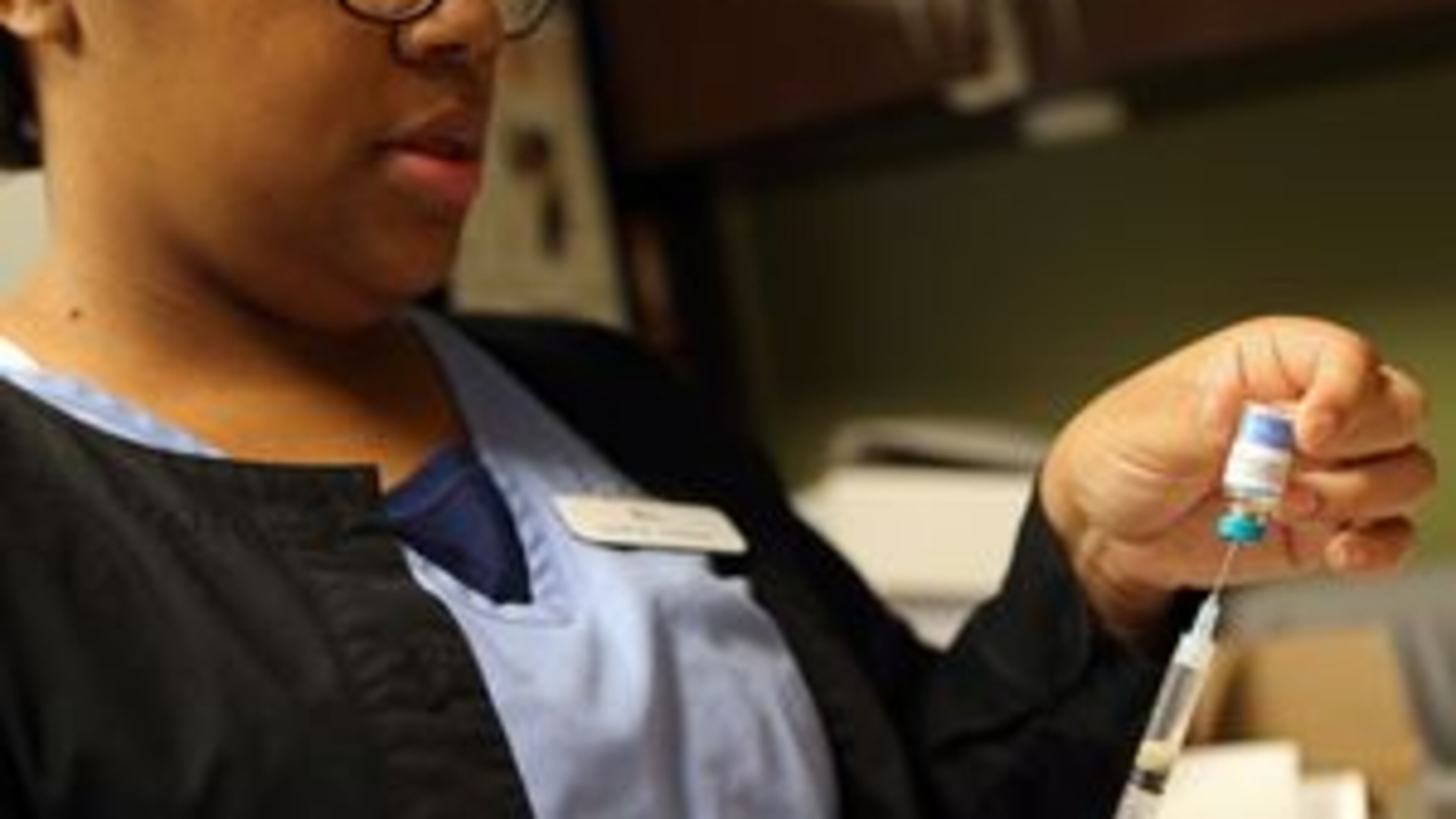 Brianna Gilyard, lead medical assistant at Intown Pediatrics & Adolescent Medicine, prepares a measles, mumps and rubella vaccine. BEN GRAY / BGRAY@AJC.COM