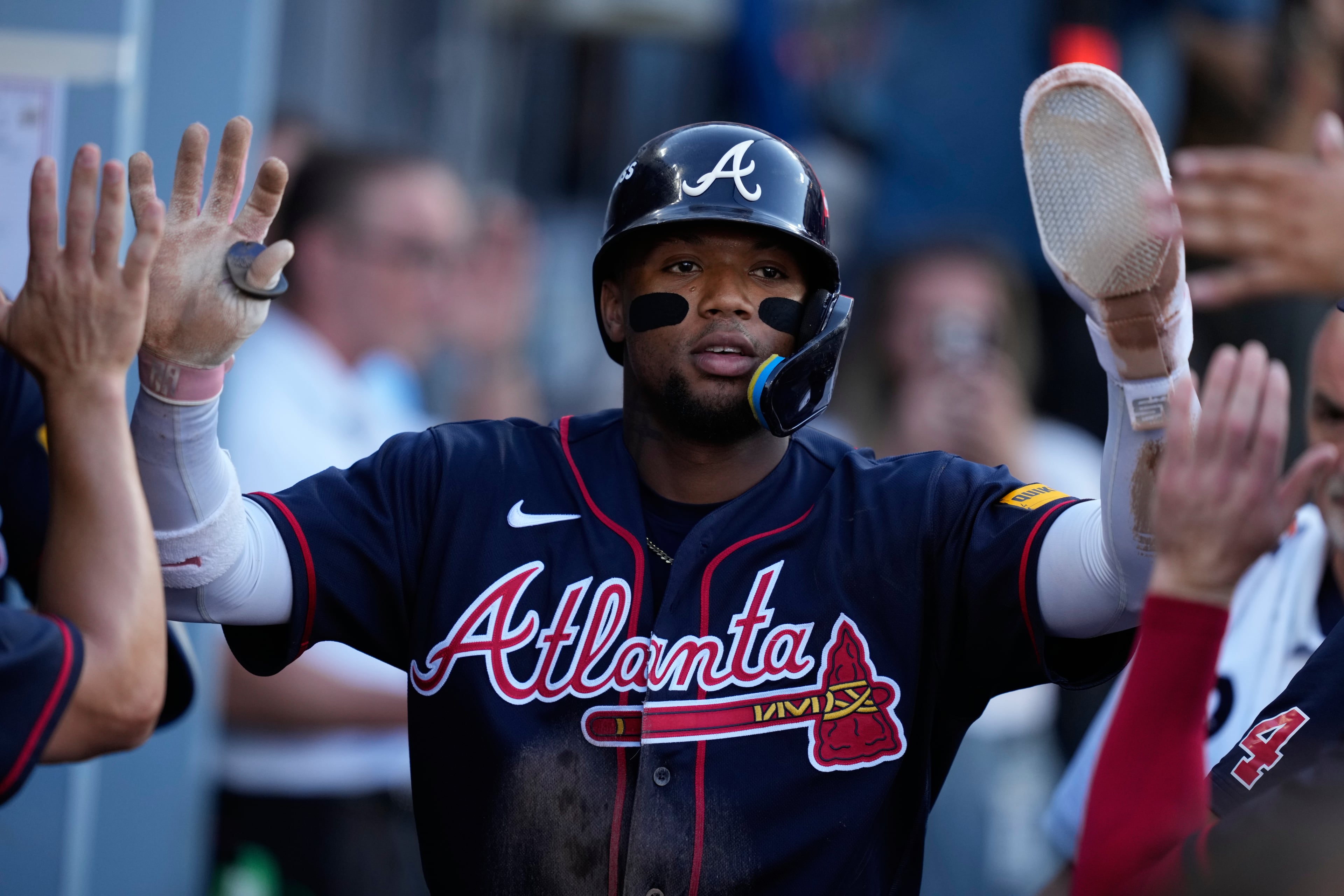Atlanta Braves' Ronald Acuña Jr. celebrates with teammates after scoring off an RBI single by Mauricio Dubón during the first inning of Game 2 of a National League Division Series baseball game against the Los Angeles Dodgers Sunday, Oct. 4, 2026, in Los Angeles. (AP Photo/Mark J. Terrill)
