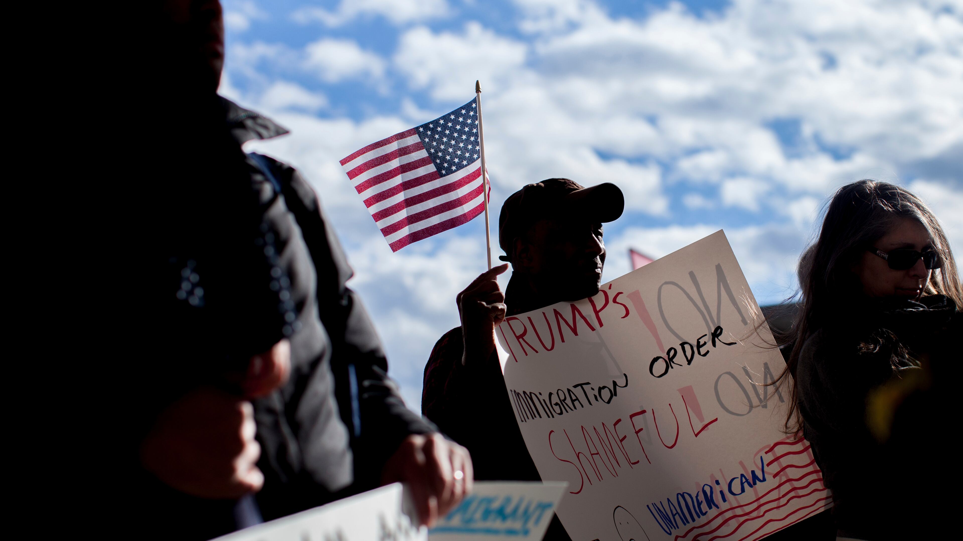 Demonstrators hold signs at Hartsfield-Jackson International Airport during a demonstration to denounce President Donald Trump's executive order that bars citizens of seven predominantly Muslim-majority countries from entering the U.S., Sunday, Jan. 29, 2017, in Atlanta. (AP Photo/Branden Camp)